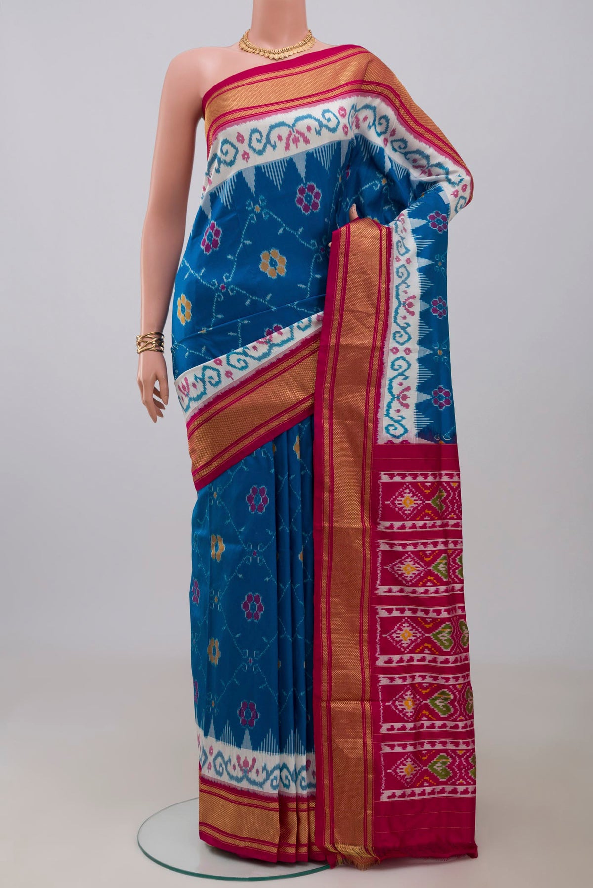 Blue Pochampally Silk Saree with Ikat design on the body and Zari Border.  displayed on a mannequin