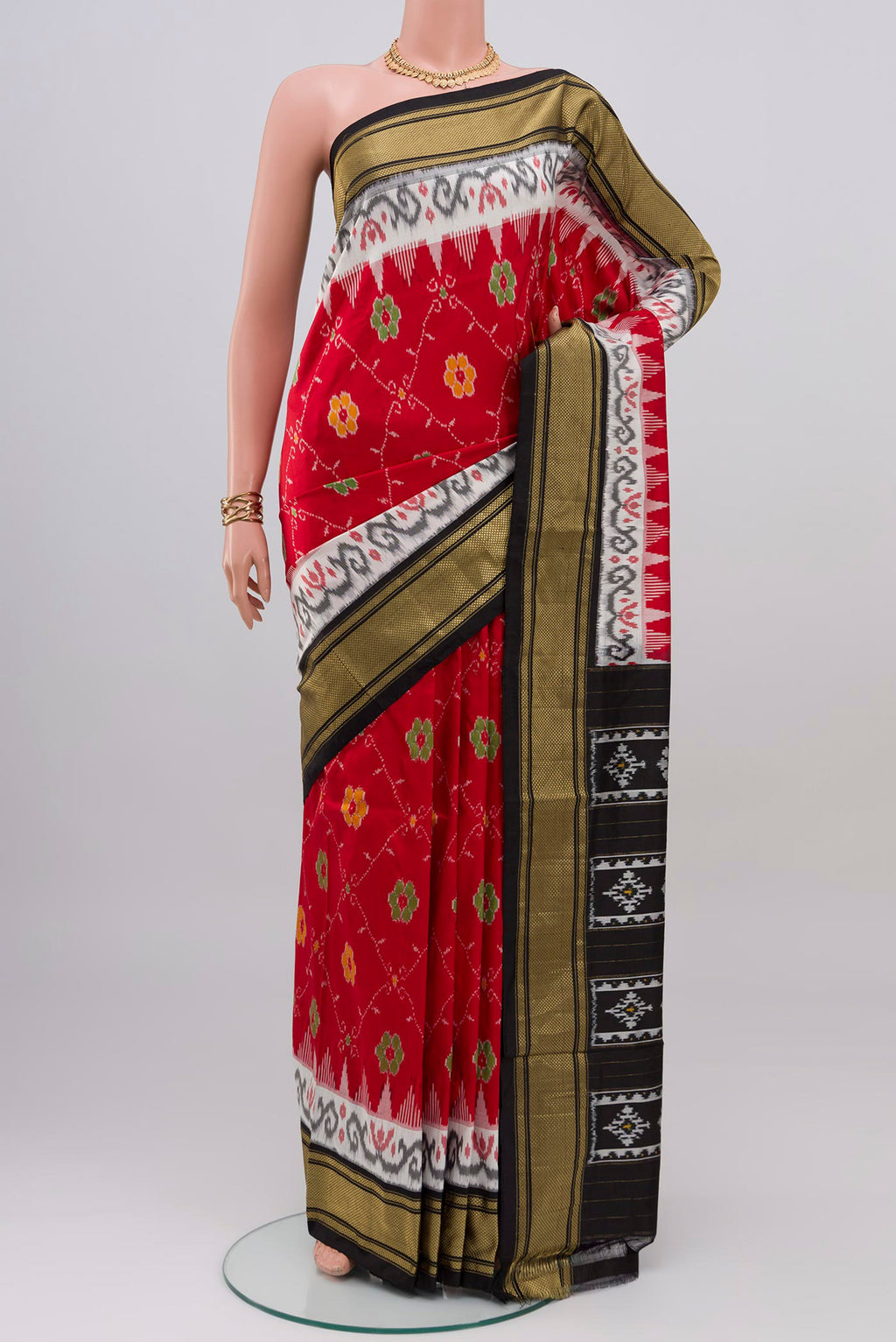 Red Pochampally Silk Saree with Ikat design on the body and Zari Border.  displayed on a mannequin