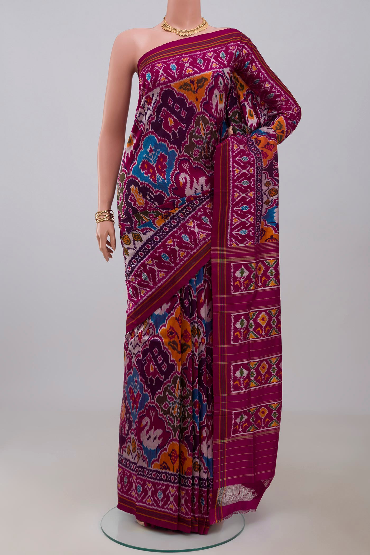 Purple Pochampally Saree with Ikat Print on the body and Ikat Border.  displayed on a mannequin