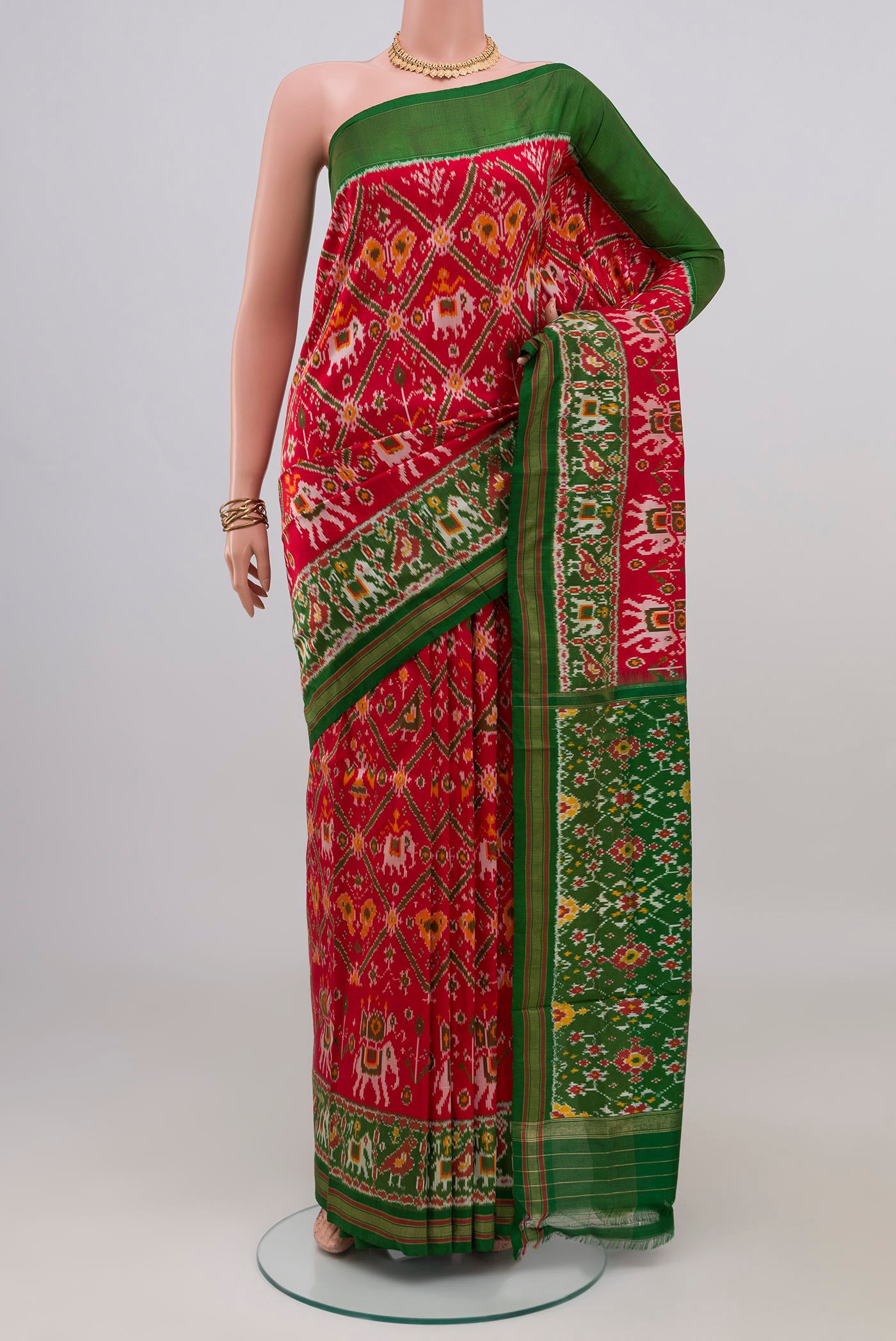 Red Pochampally Silk Saree with Ikat design on the body and Zari Border.  displayed on a mannequin