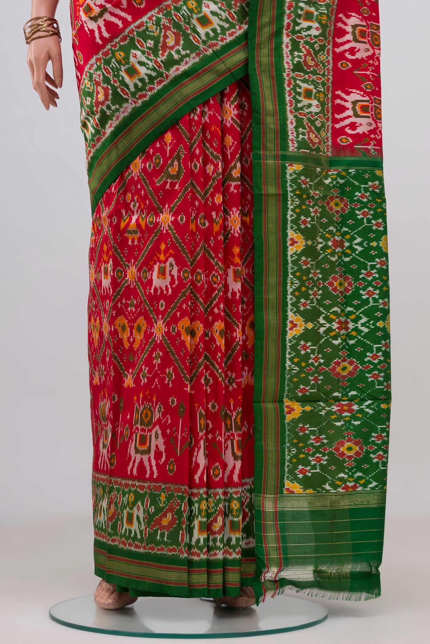 Pleats and pallu of Red Pochampally Silk Saree with Ikat design on the body and Zari Border. 