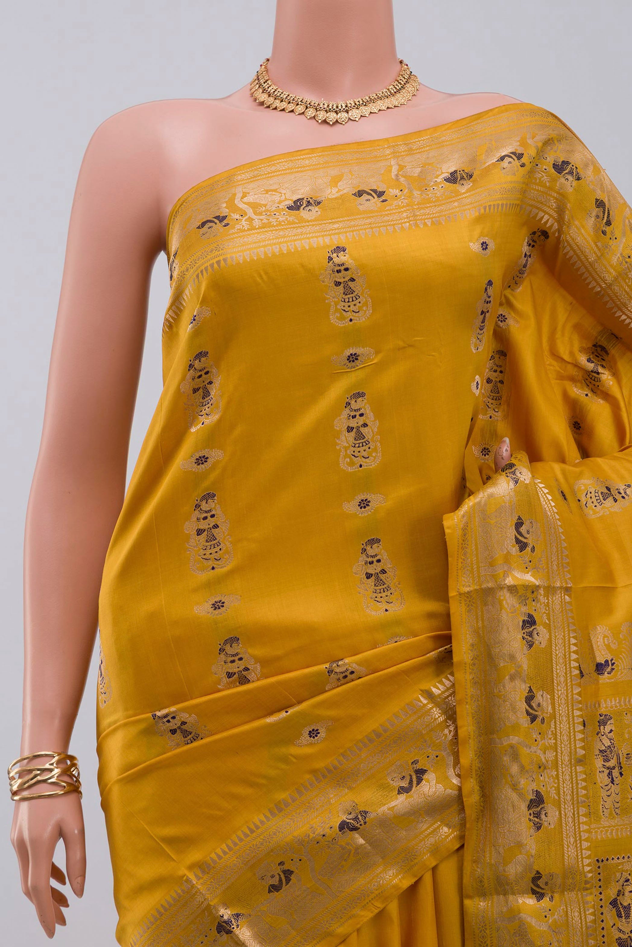 Border image of Yellow Baluchari Silk Saree with Zari Butta on the body and Zari Border. 
