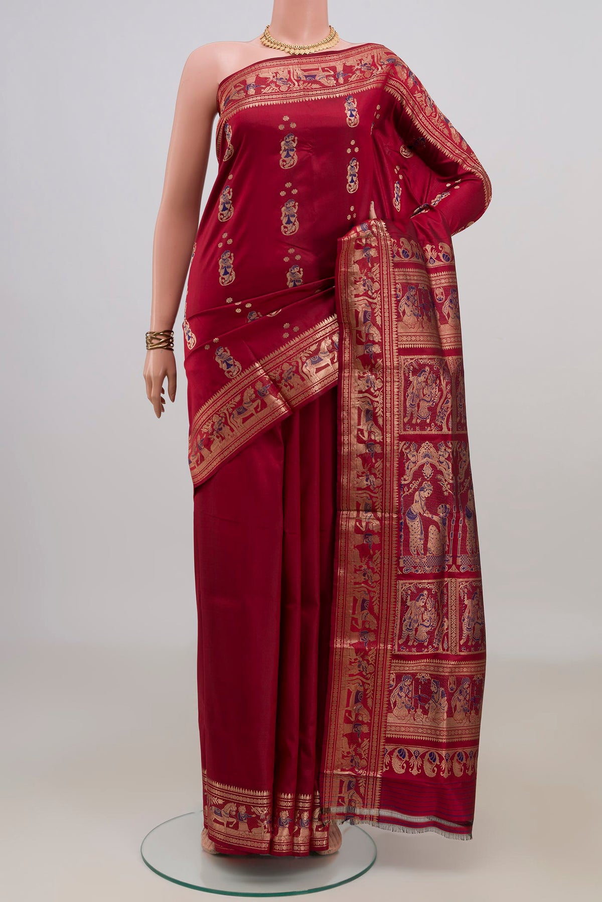 Pure Silk Maroon Baluchari Saree with Zari And Thread Butta on the body and Fancy Border.  displayed on a mannequin