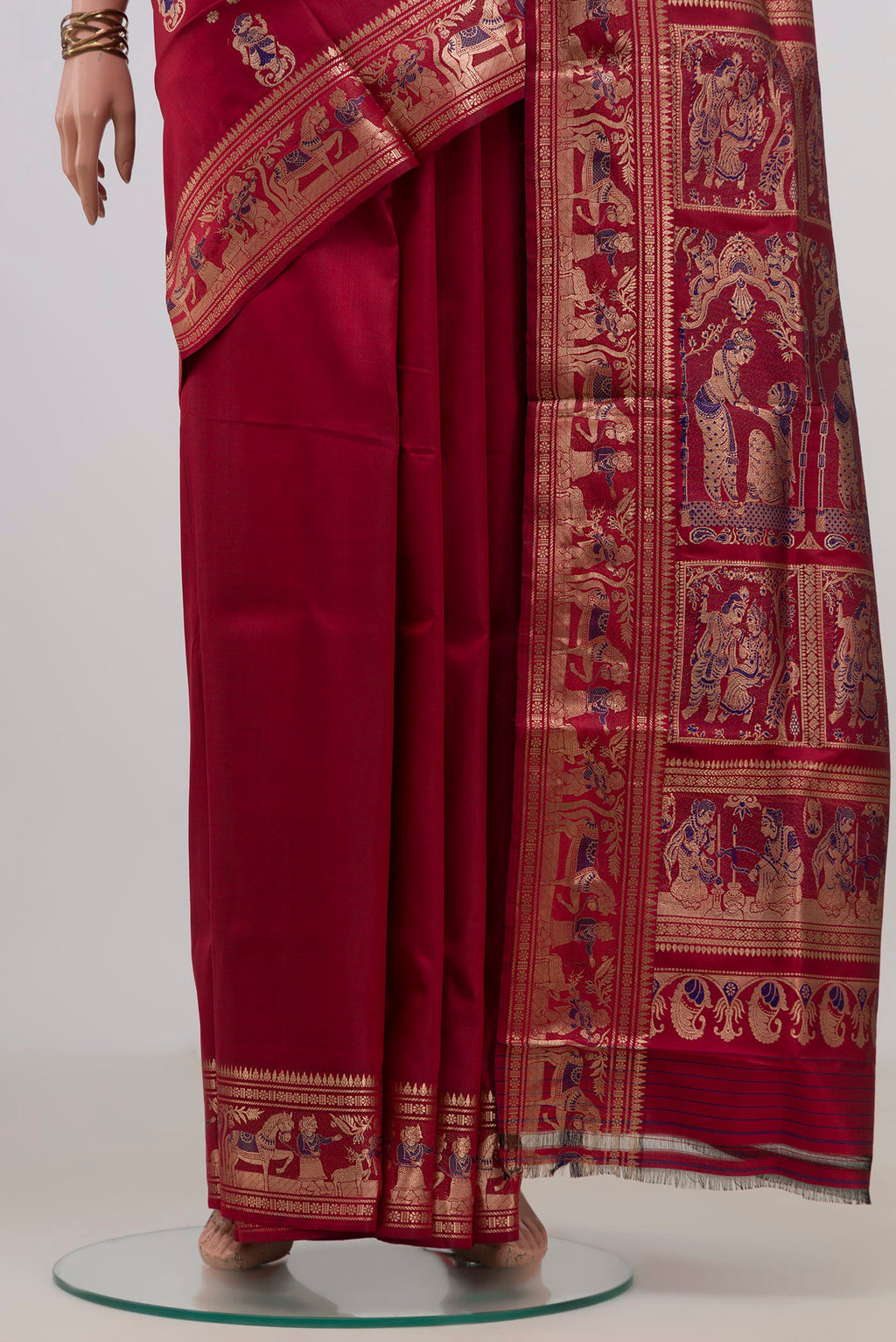 Pleats and pallu of Pure Silk Maroon Baluchari Saree with Zari And Thread Butta on the body and Fancy Border. 