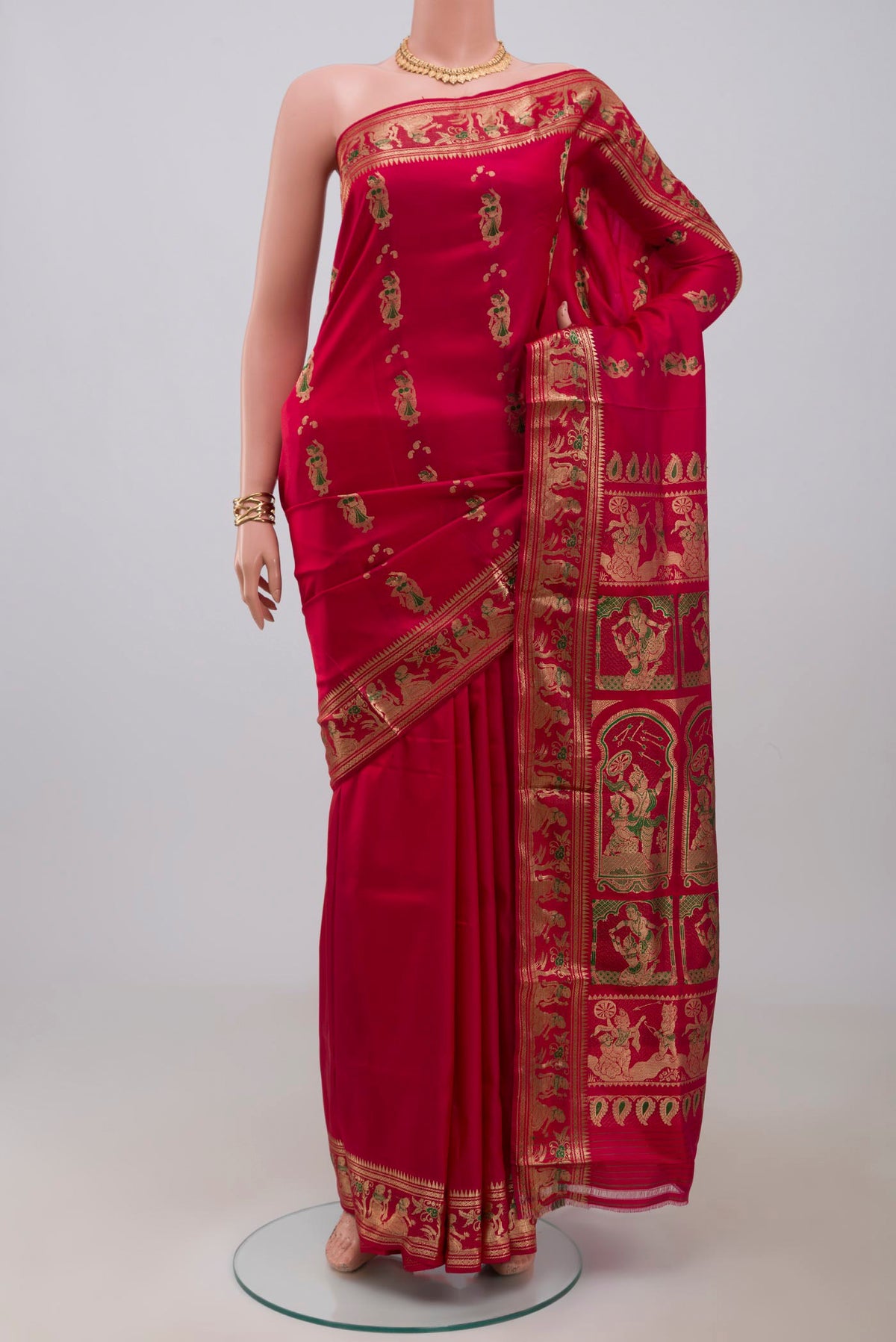 Red Baluchari Silk Saree with Zari And Thread Butta on the body and Zari Border.  displayed on a mannequin
