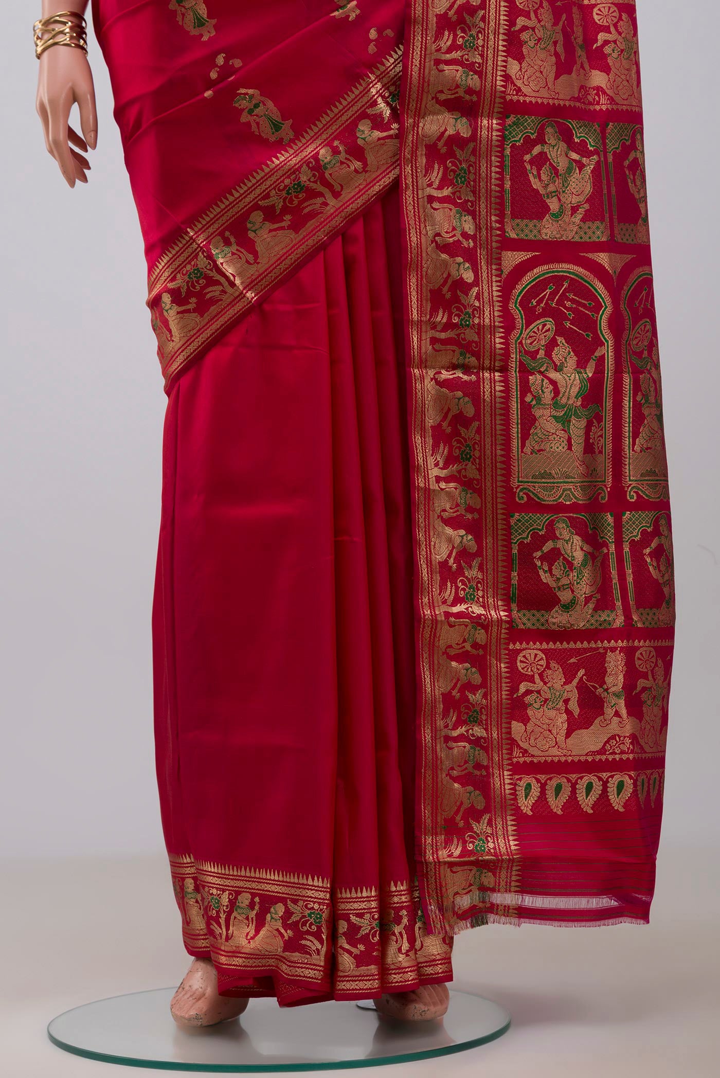 Pleats and pallu of Red Baluchari Silk Saree with Zari And Thread Butta on the body and Zari Border. 