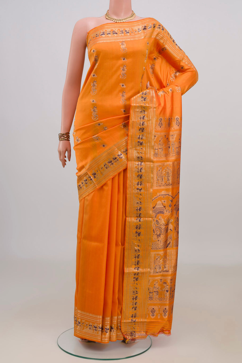 Pure Silk Orange Baluchari Saree with Zari And Thread Butta on the body and Zari Border.  displayed on a mannequin