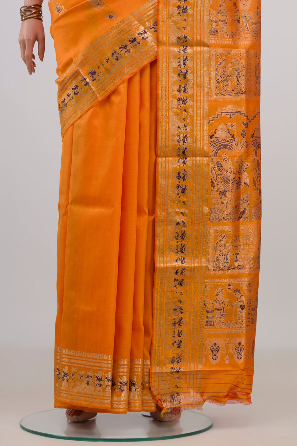 Pleats and pallu of Pure Silk Orange Baluchari Saree with Zari And Thread Butta on the body and Zari Border. 