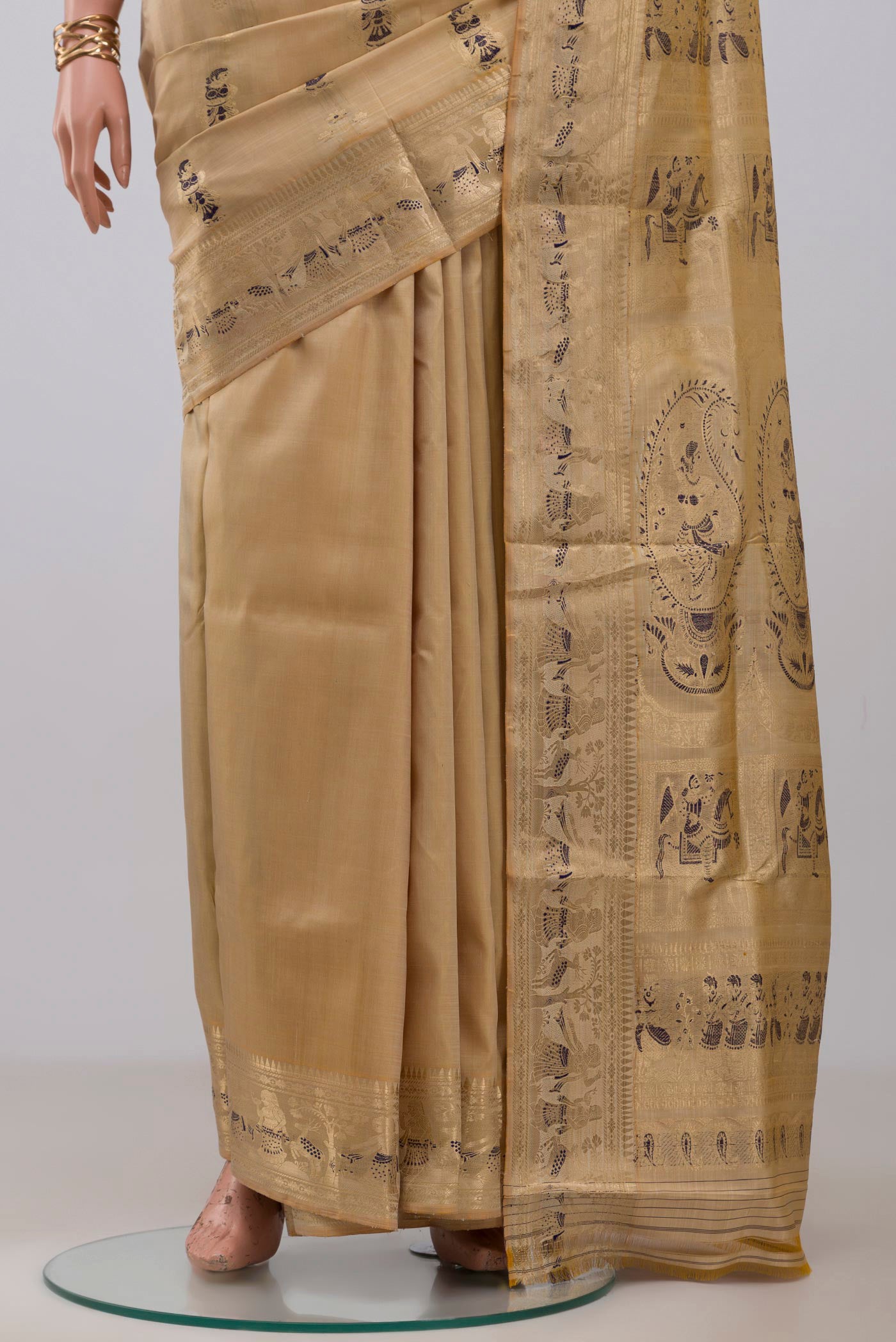 Pleats and pallu of Beige Baluchari Silk Saree with Zari And Thread Butta on the body and Zari Border. 