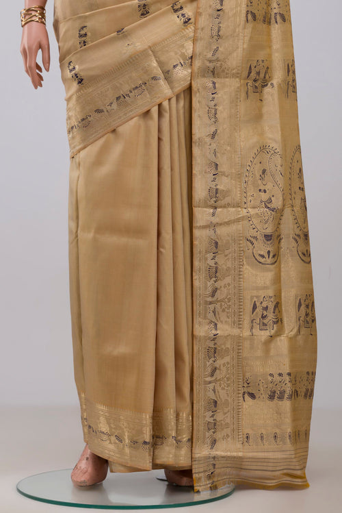 Pleats and pallu of Beige Baluchari Silk Saree with Zari And Thread Butta on the body and Zari Border. 