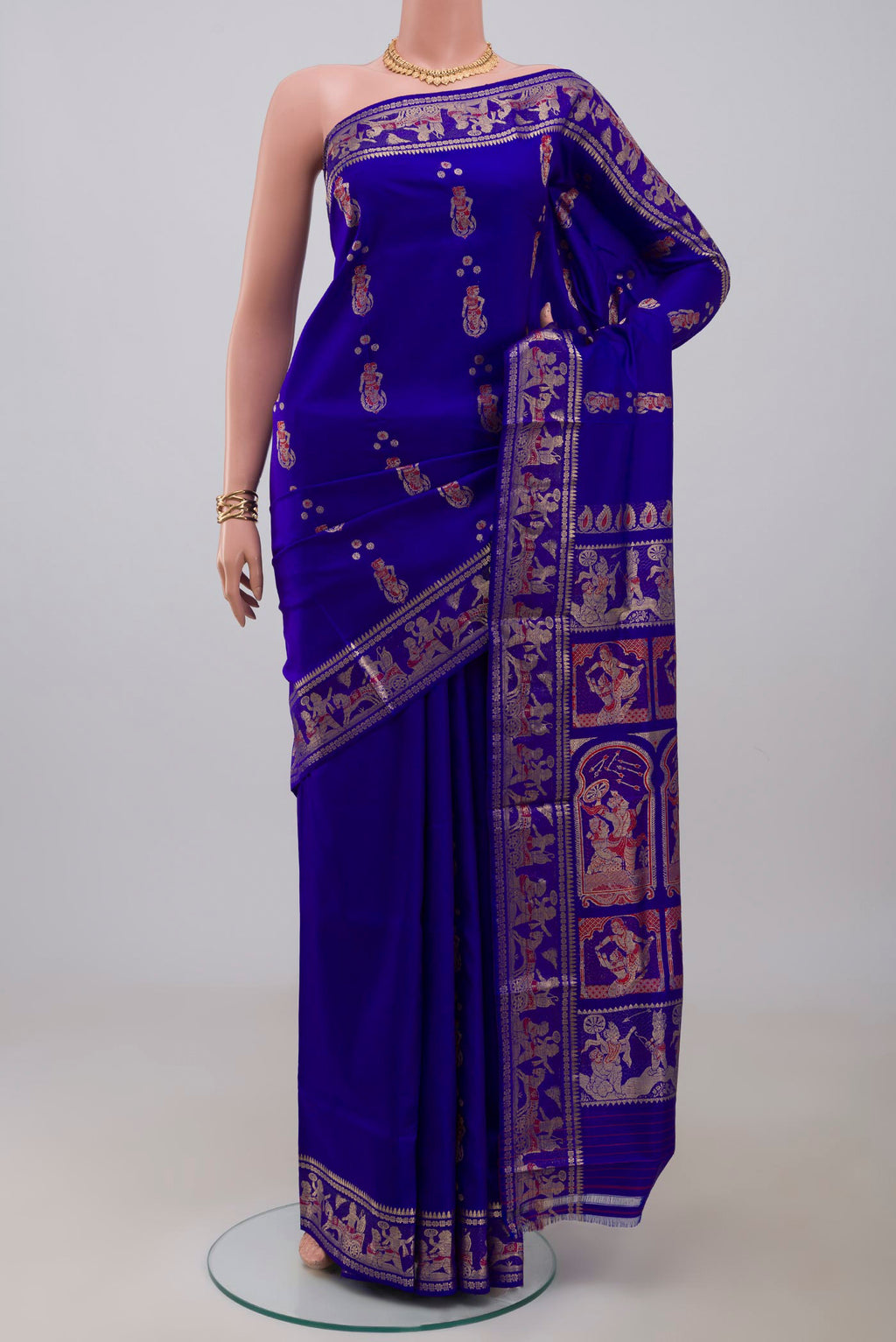Blue Baluchari Silk Saree with Zari And Thread Butta on the body and Zari Border.  displayed on a mannequin