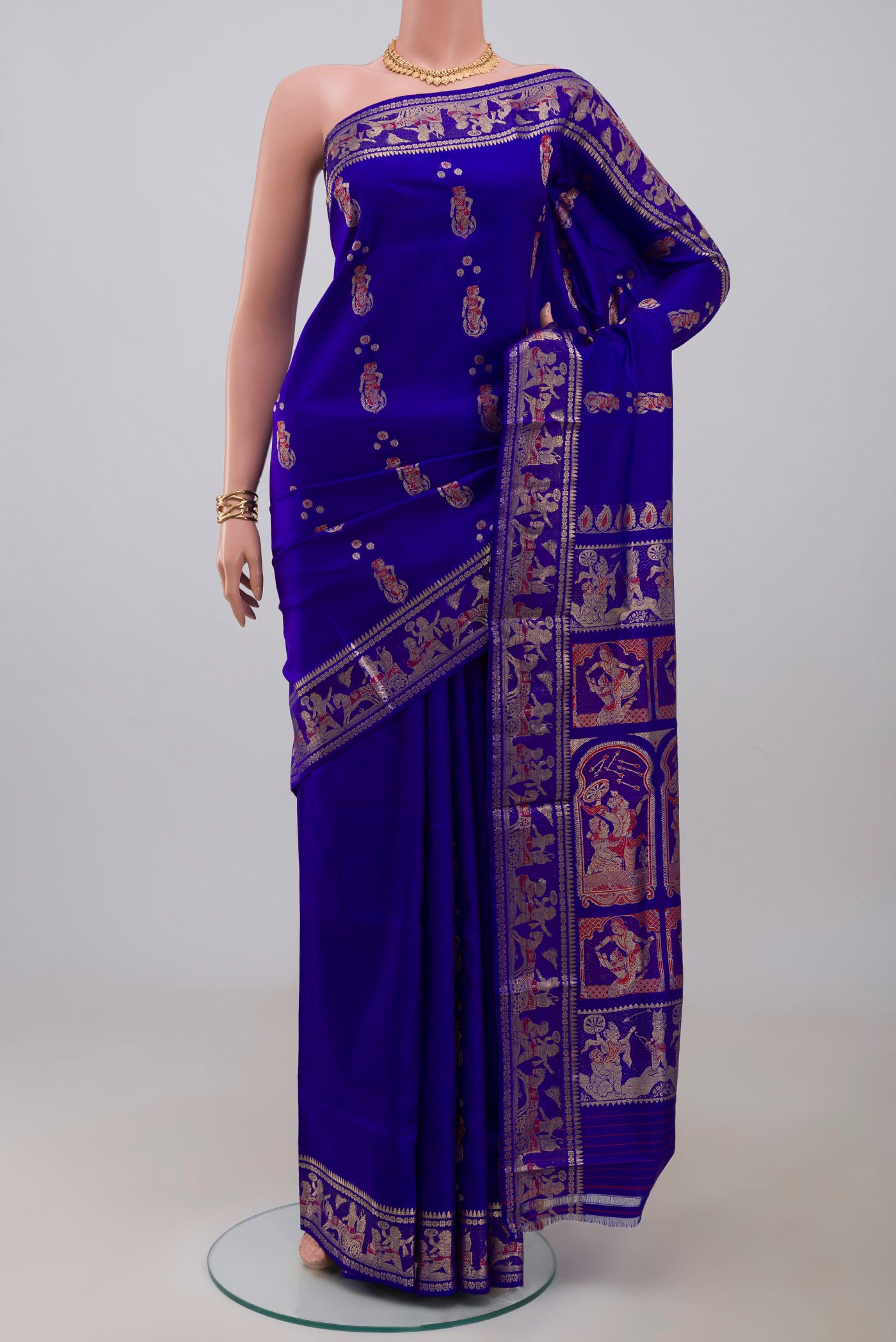 Blue Baluchari Silk Saree with Zari And Thread Butta on the body and Zari Border.  displayed on a mannequin