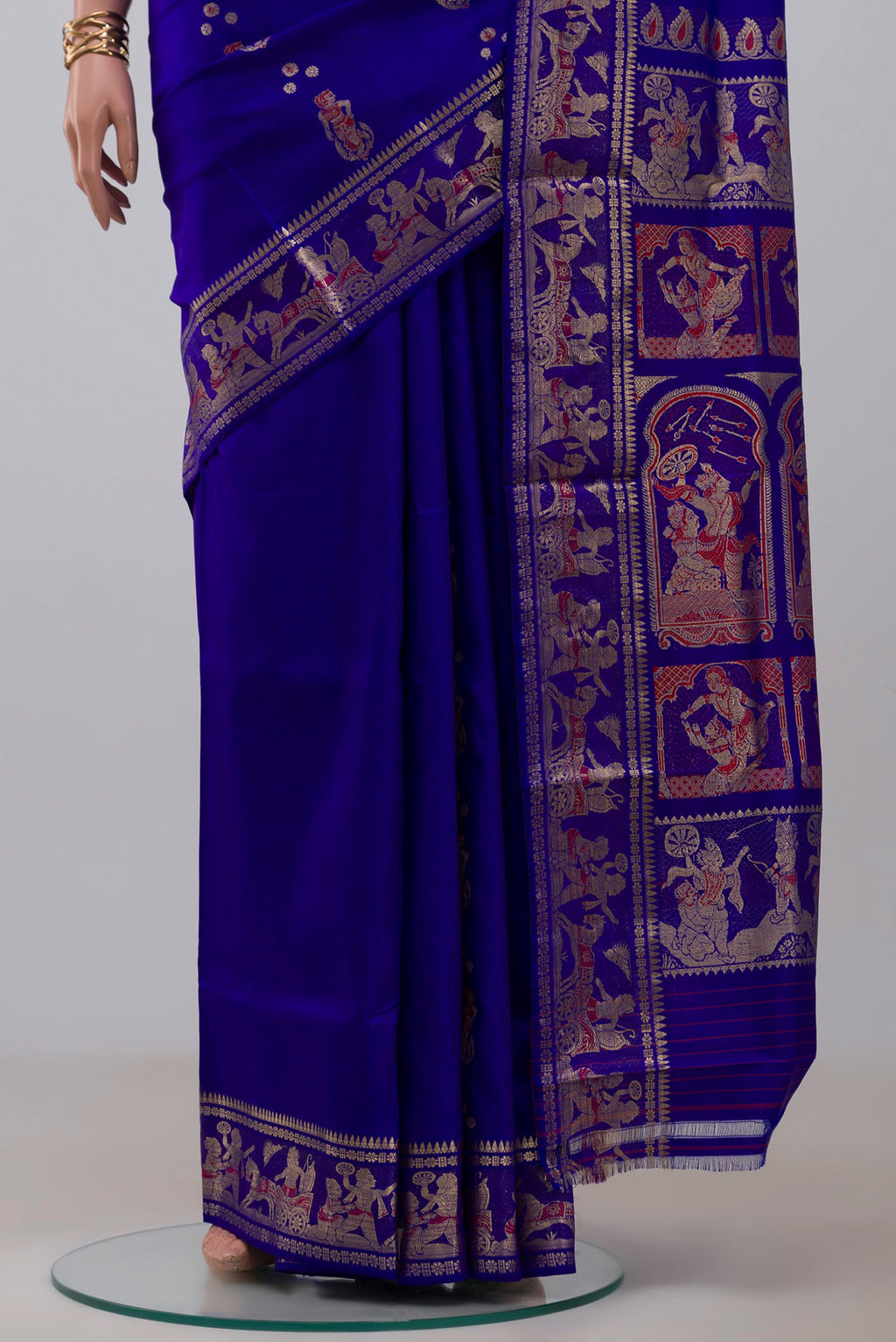 Pleats and pallu of Blue Baluchari Silk Saree with Zari And Thread Butta on the body and Zari Border. 