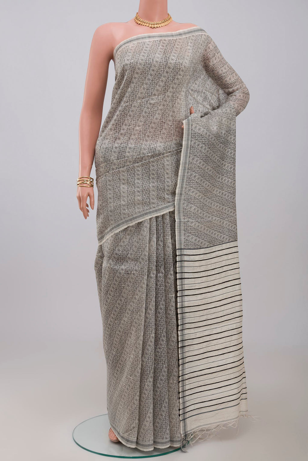 Cream Jute Silk Saree with Fancy on the body and Plain Border.  displayed on a mannequin
