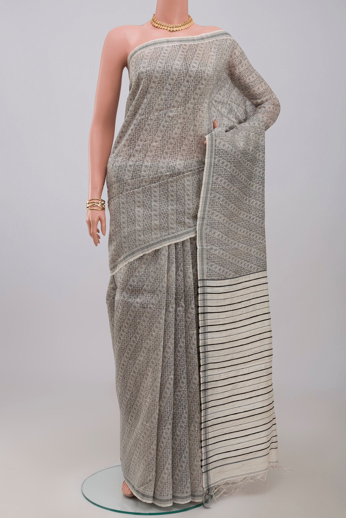 Cream Jute Silk Saree with Fancy on the body and Plain Border.  displayed on a mannequin