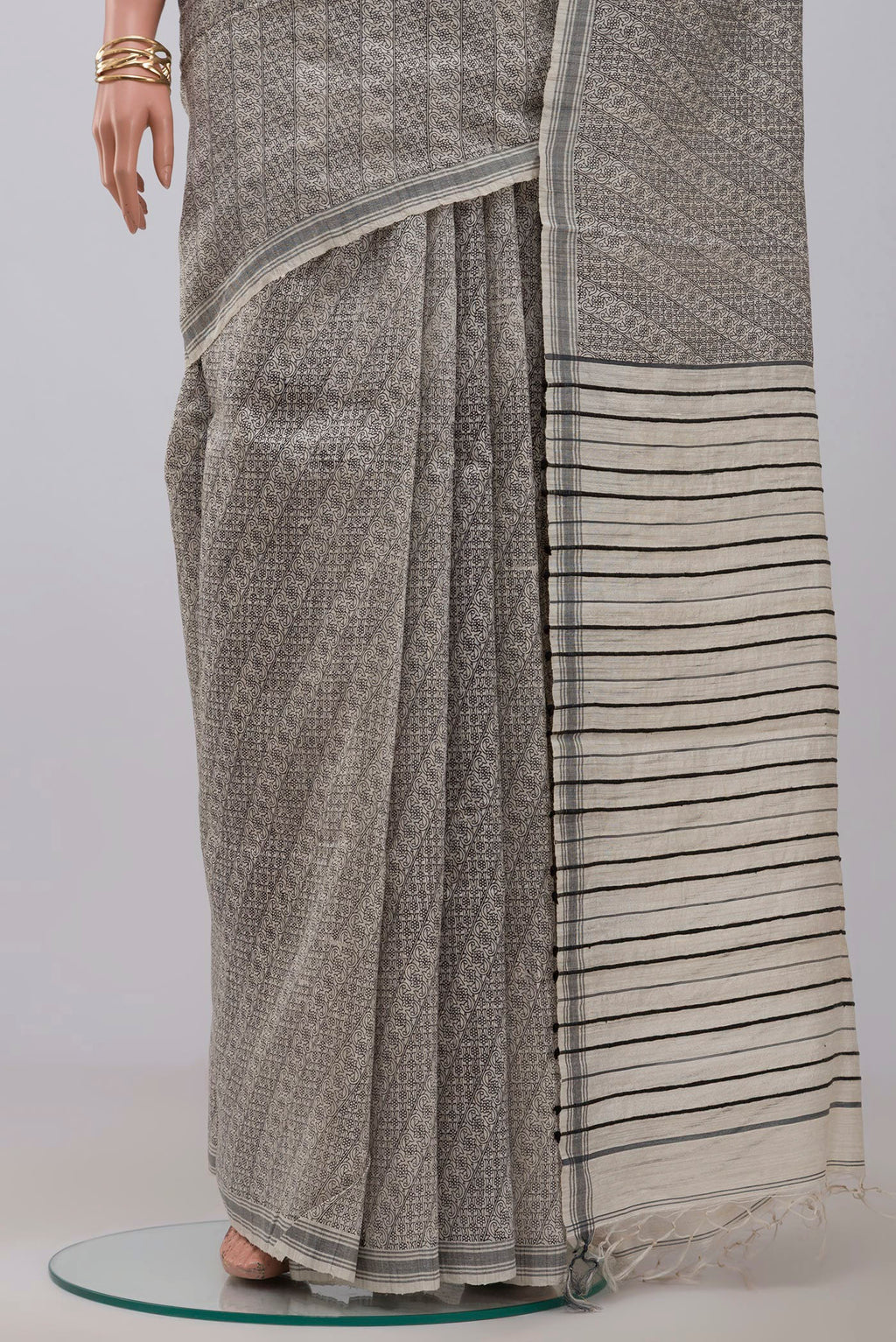 Pleats and pallu of Cream Jute Silk Saree with Fancy on the body and Plain Border. 