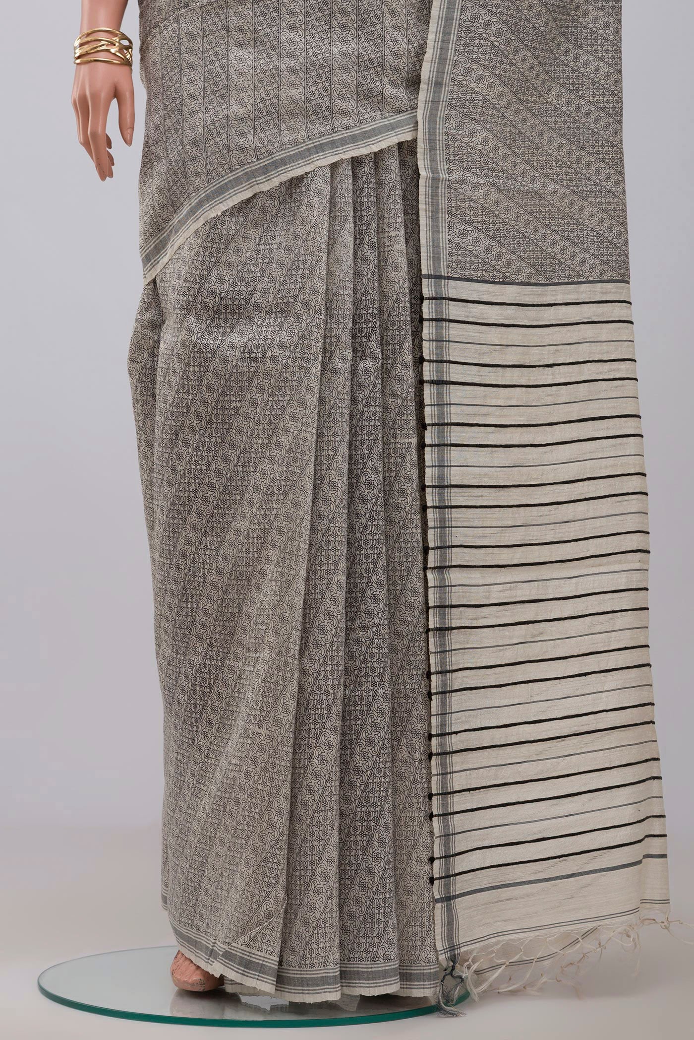 Pleats and pallu of Cream Jute Silk Saree with Fancy on the body and Plain Border. 