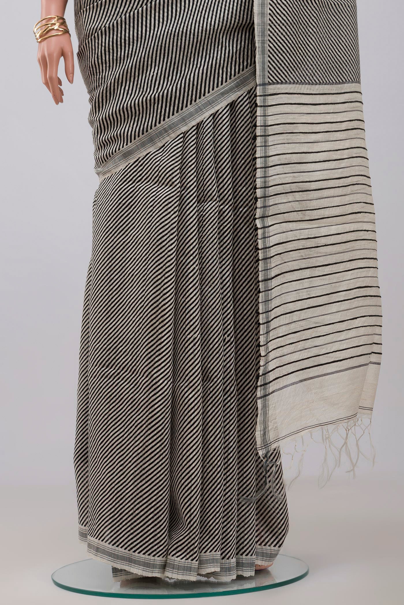 Pleats and pallu of Cream Jute Silk Saree with Fancy on the body and Plain Border. 