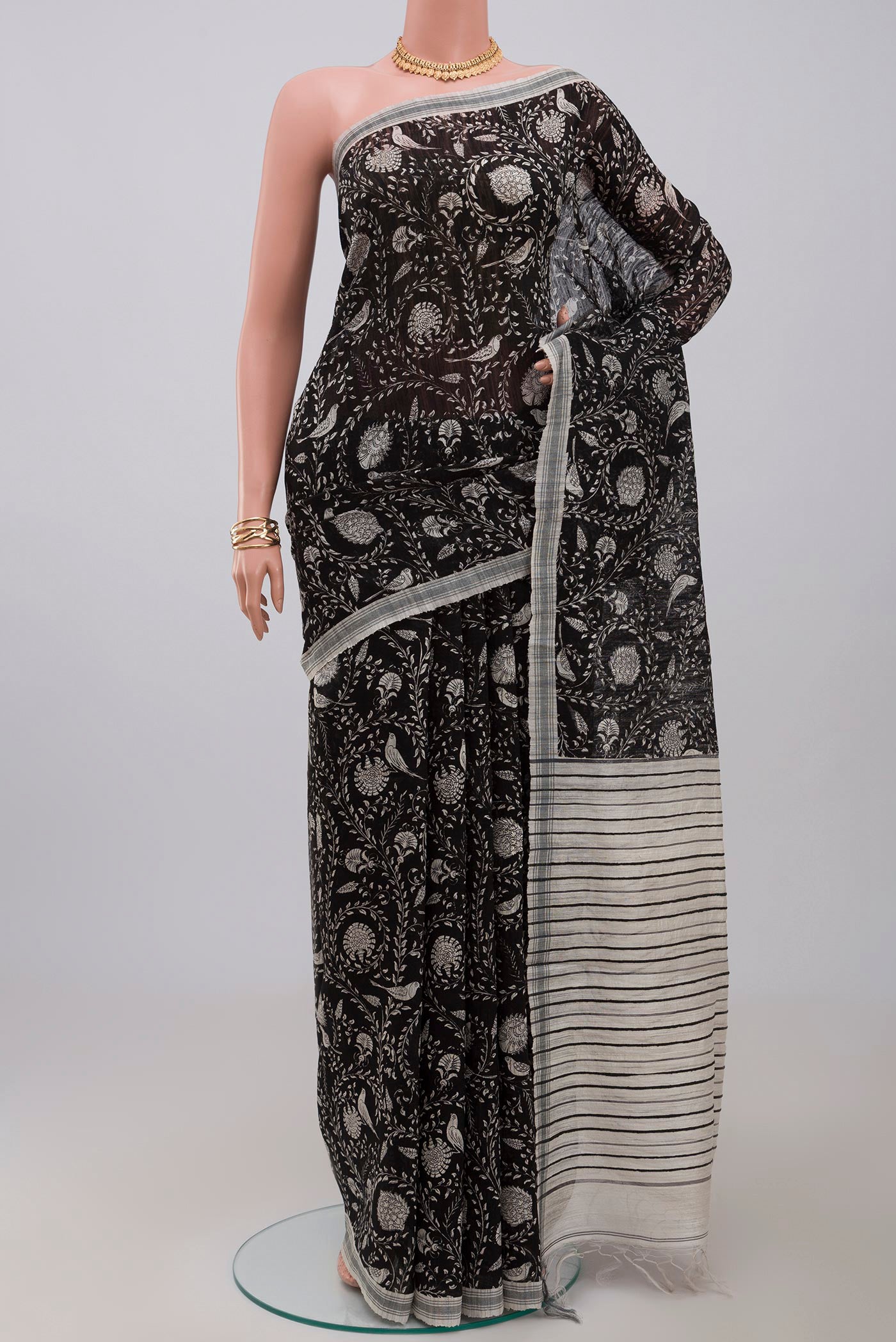 Black Jute Silk Saree with Fancy on the body and Plain Border.  displayed on a mannequin