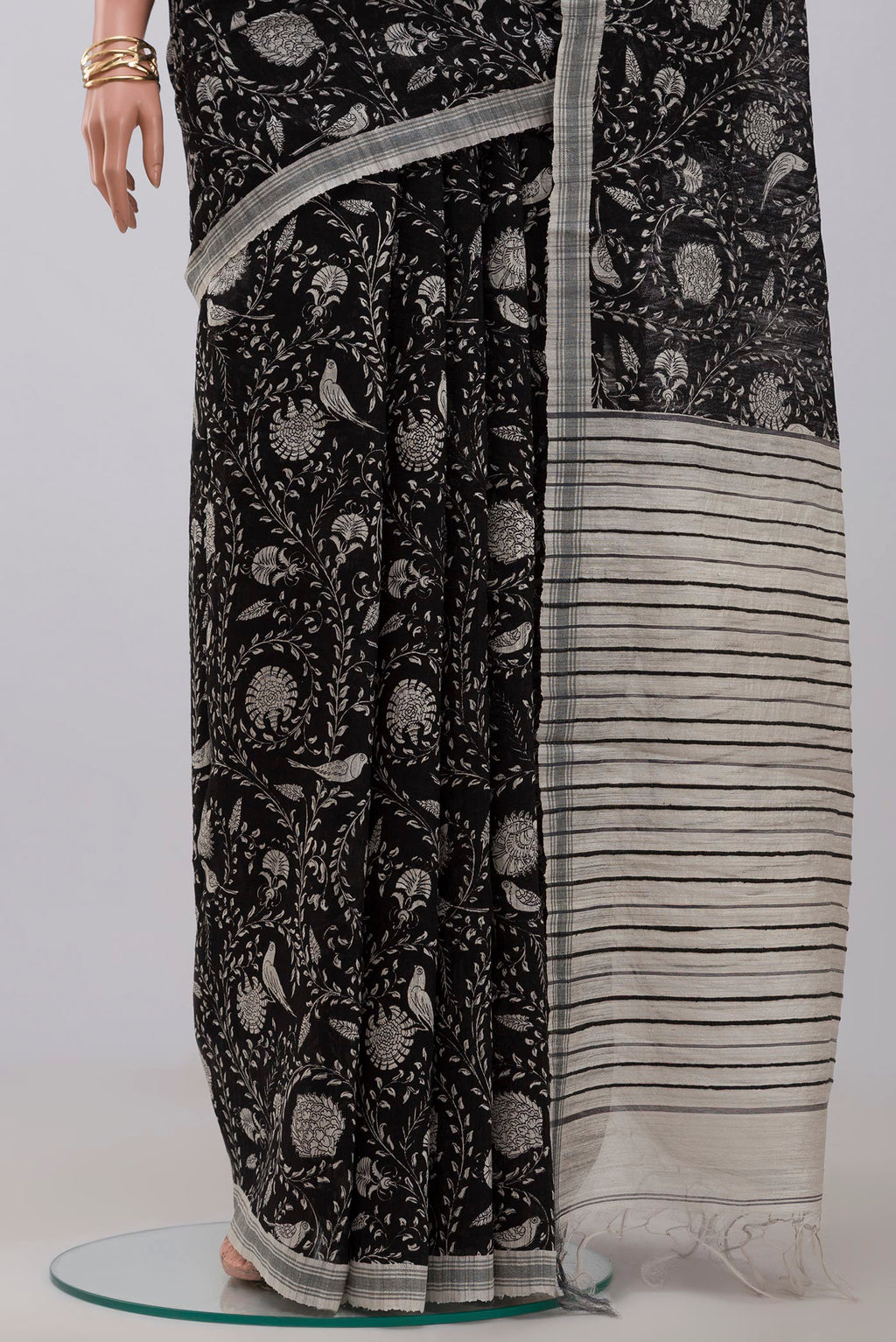 Pleats and pallu of Black Jute Silk Saree with Fancy on the body and Plain Border. 