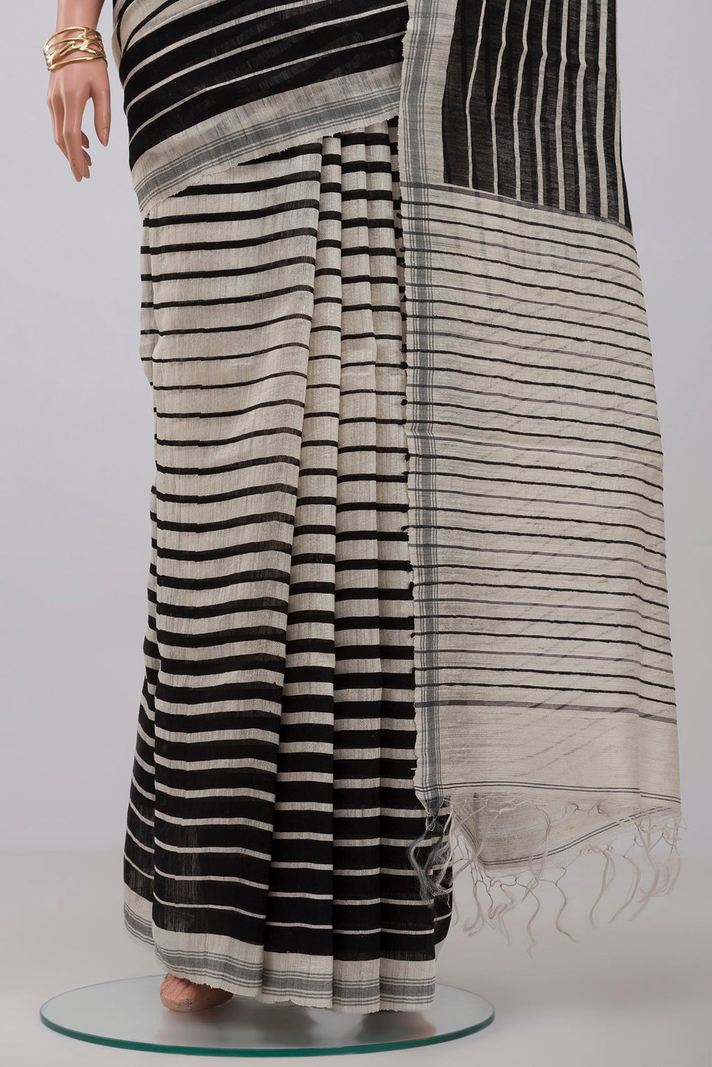 Pleats and pallu of Cream Jute Silk Saree with Fancy on the body and Plain Border. 