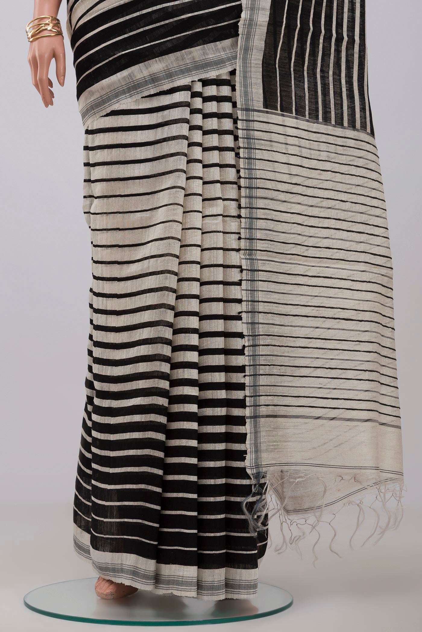 Pleats and pallu of Cream Jute Silk Saree with Fancy on the body and Plain Border. 