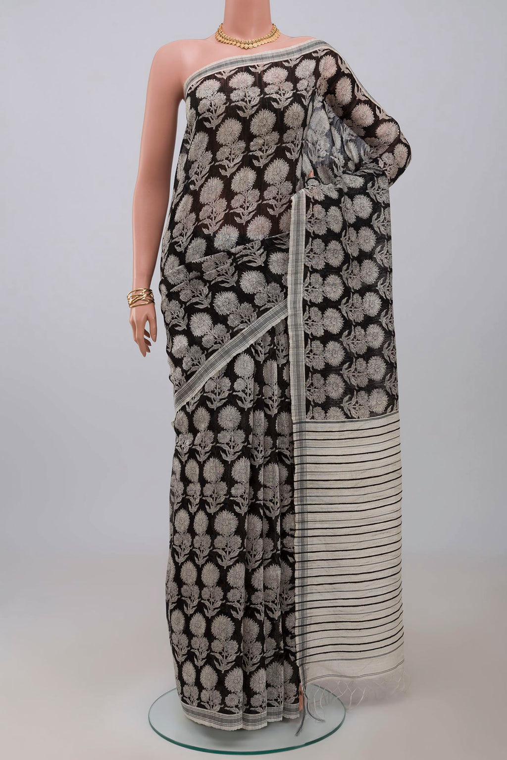 Black Tussar Silk Saree with Printed design on the body and Plain Border.  displayed on a mannequin