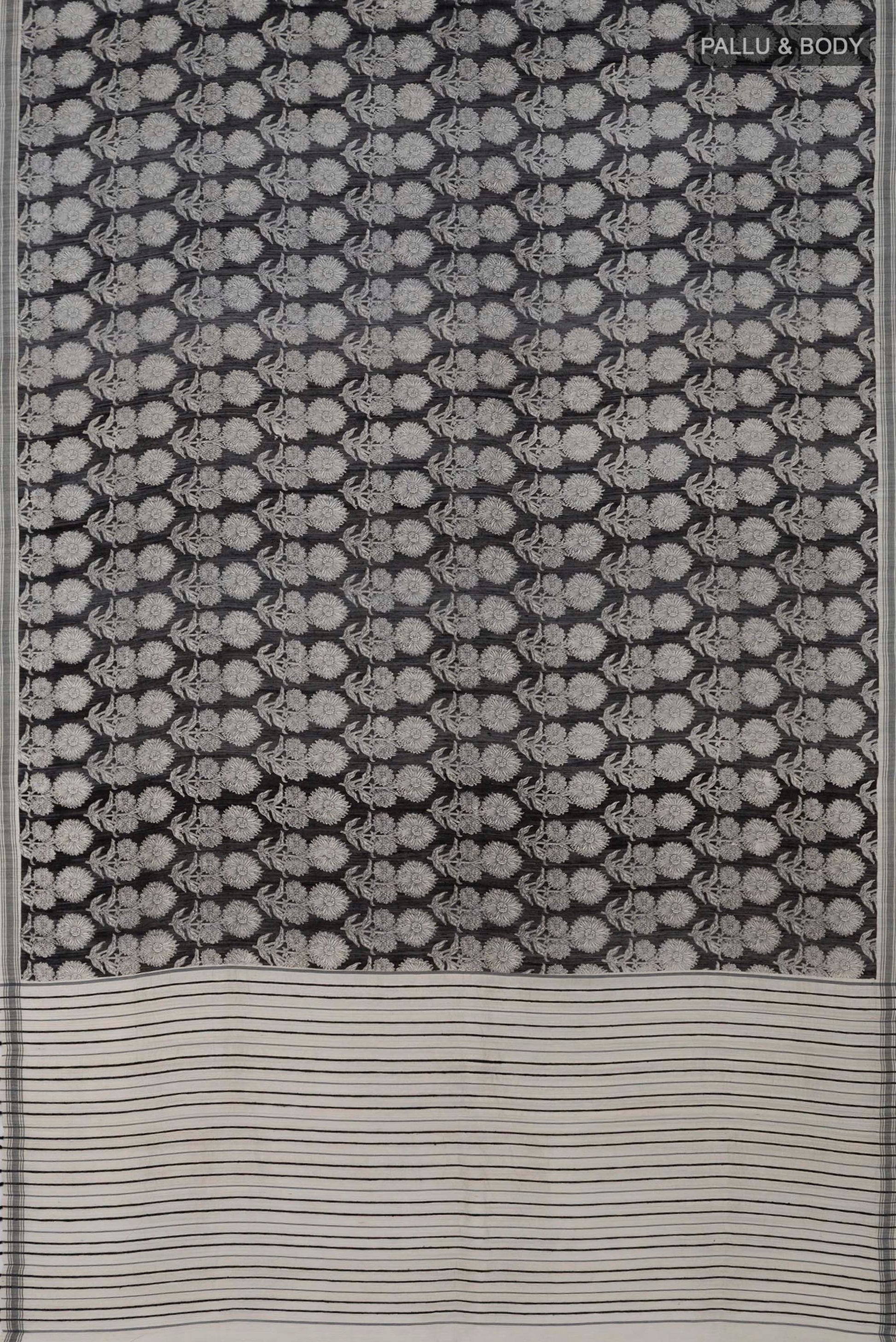 Flat view of Black Tussar Silk Saree with Printed design on the body and Plain Border. 