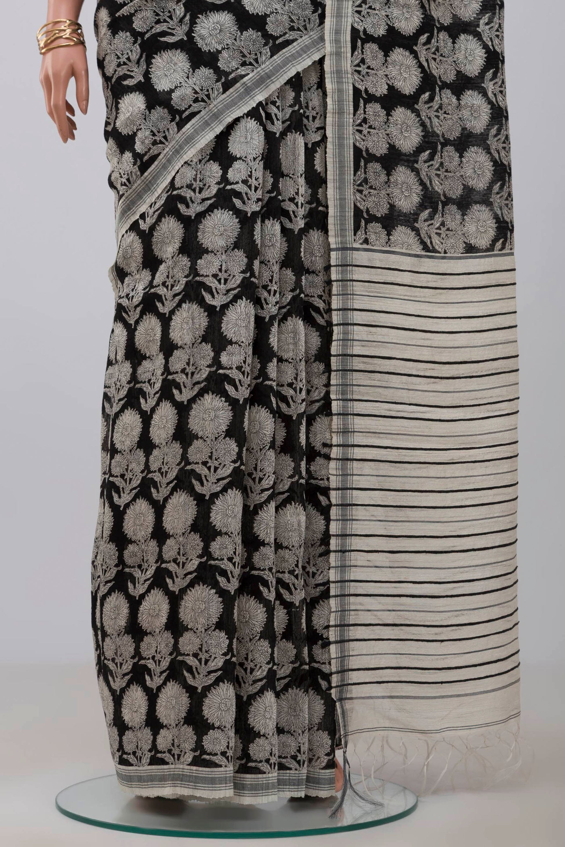 Pleats and pallu of Black Tussar Silk Saree with Printed design on the body and Plain Border. 