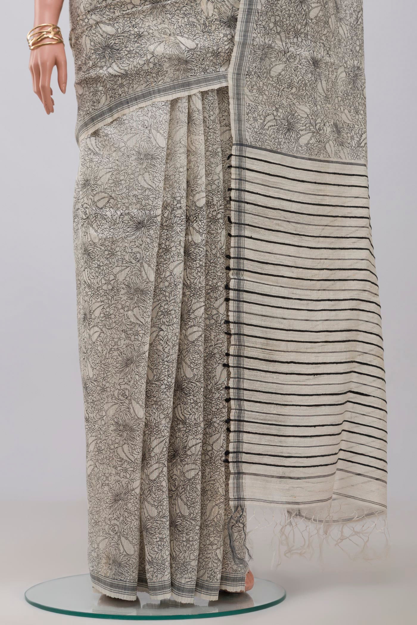 Pleats and pallu of Cream Jute Silk Saree with Fancy on the body and Plain Border. 