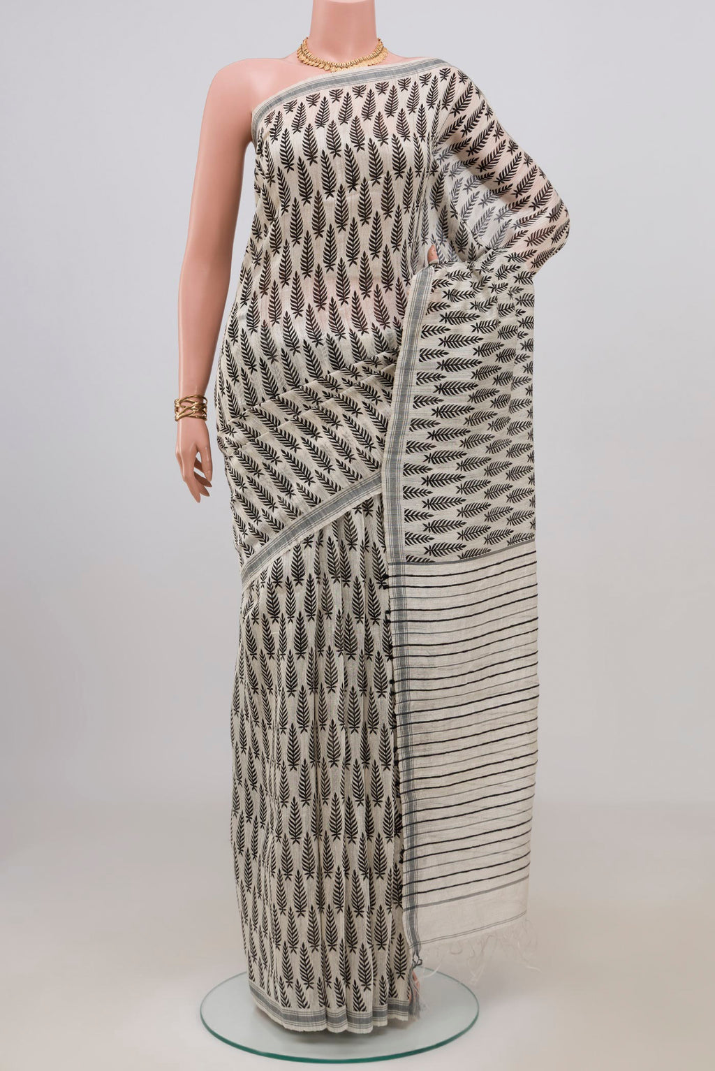 White Tussar Silk Saree with Printed design on the body and Plain Border.  displayed on a mannequin