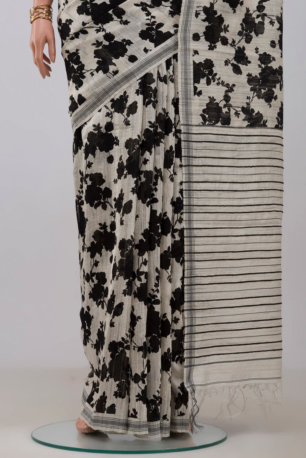Pleats and pallu of Cream Tussar Silk Saree with Floral Print on the body and Plain Border. 