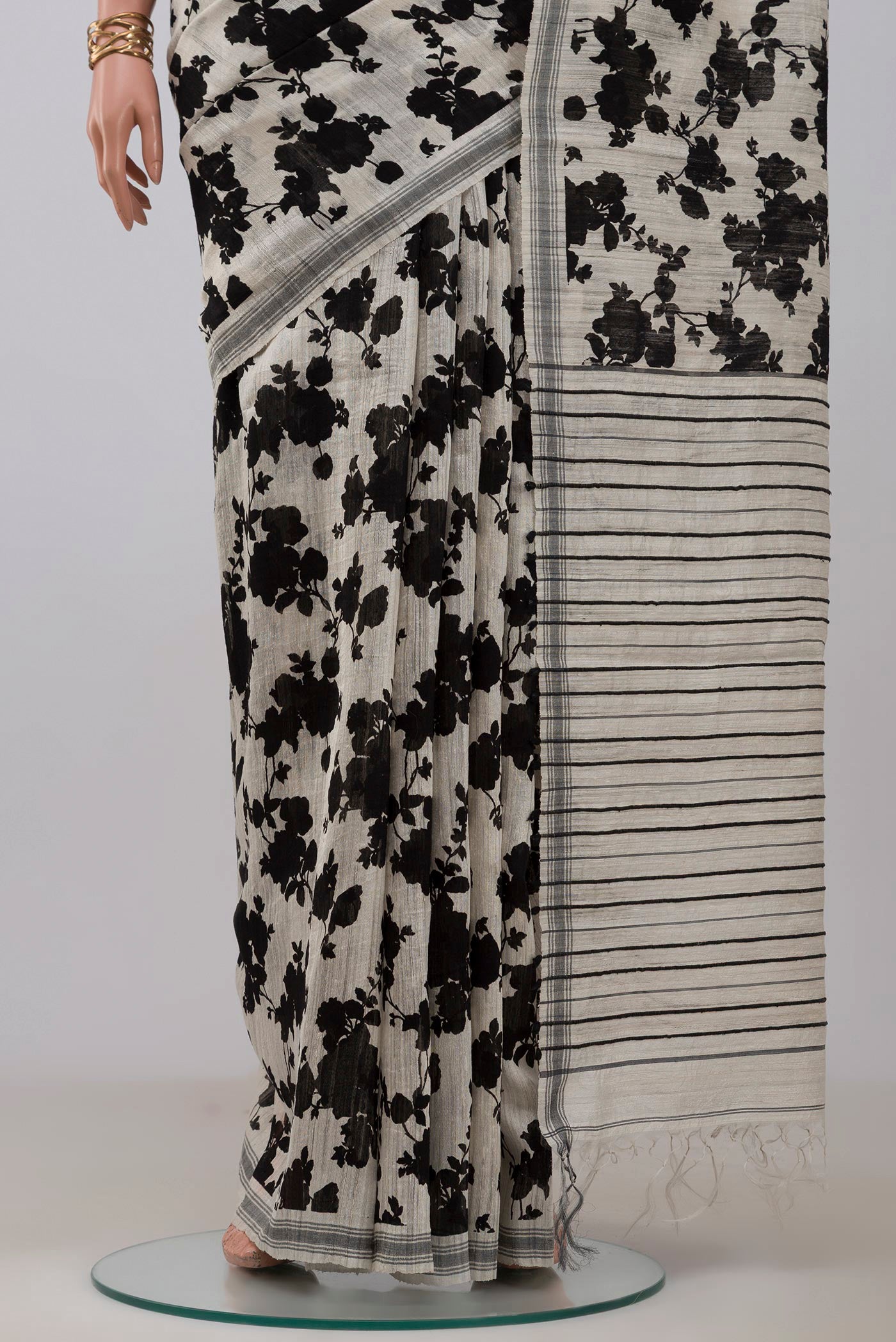 Pleats and pallu of Cream Tussar Silk Saree with Floral Print on the body and Plain Border. 