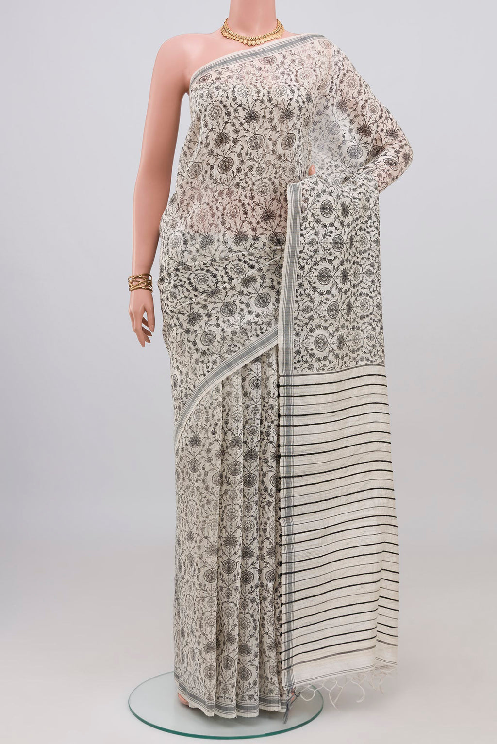 White Tussar Silk Saree with Floral Print on the body and Plain Border.  displayed on a mannequin