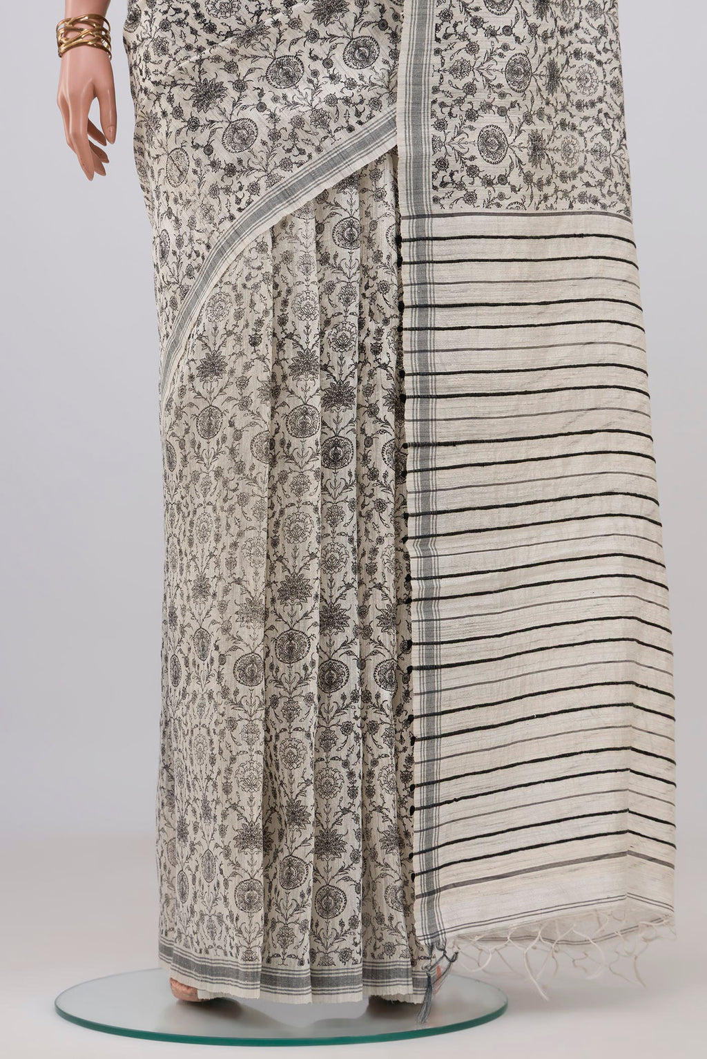 Pleats and pallu of White Tussar Silk Saree with Floral Print on the body and Plain Border. 