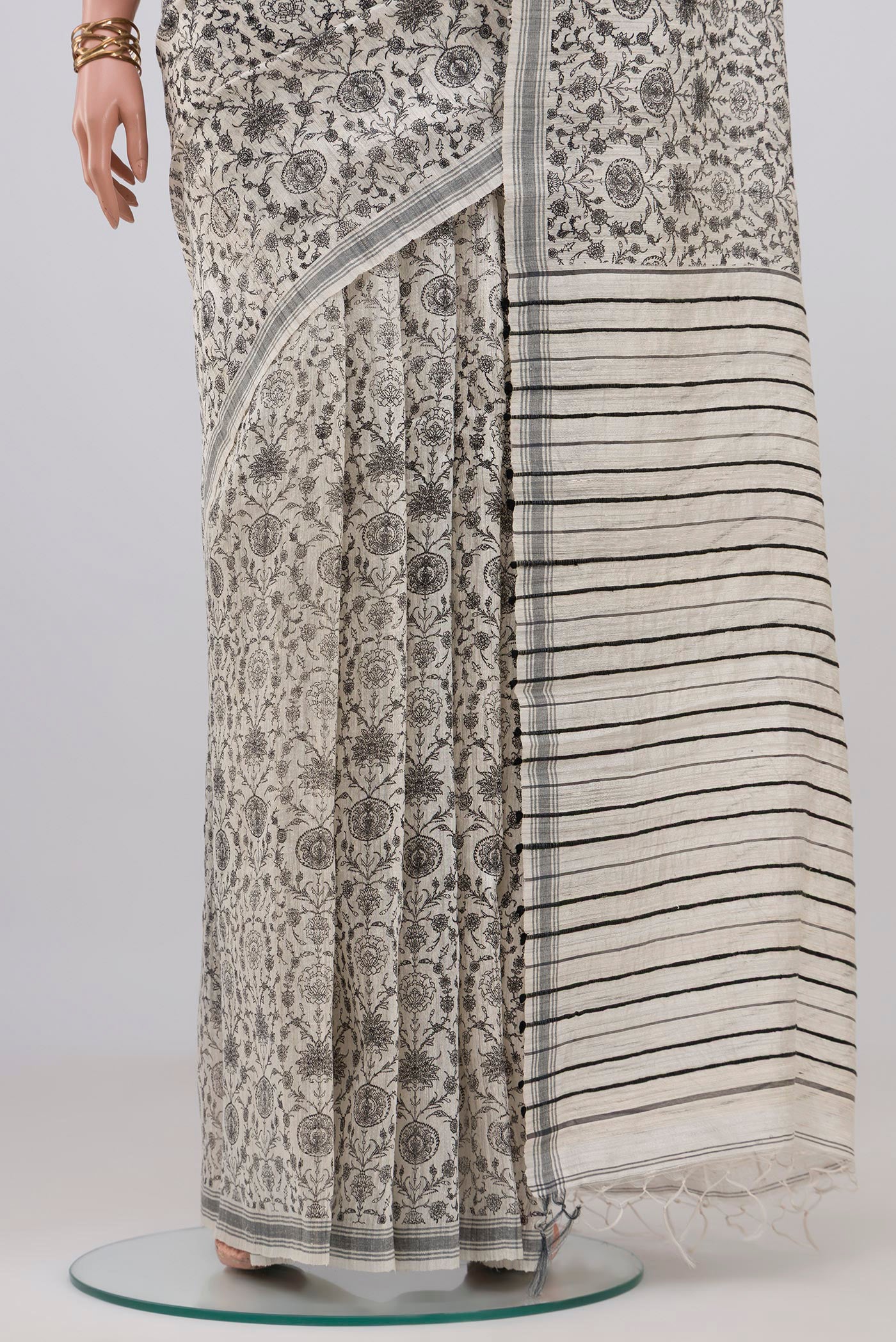 Pleats and pallu of White Tussar Silk Saree with Floral Print on the body and Plain Border. 