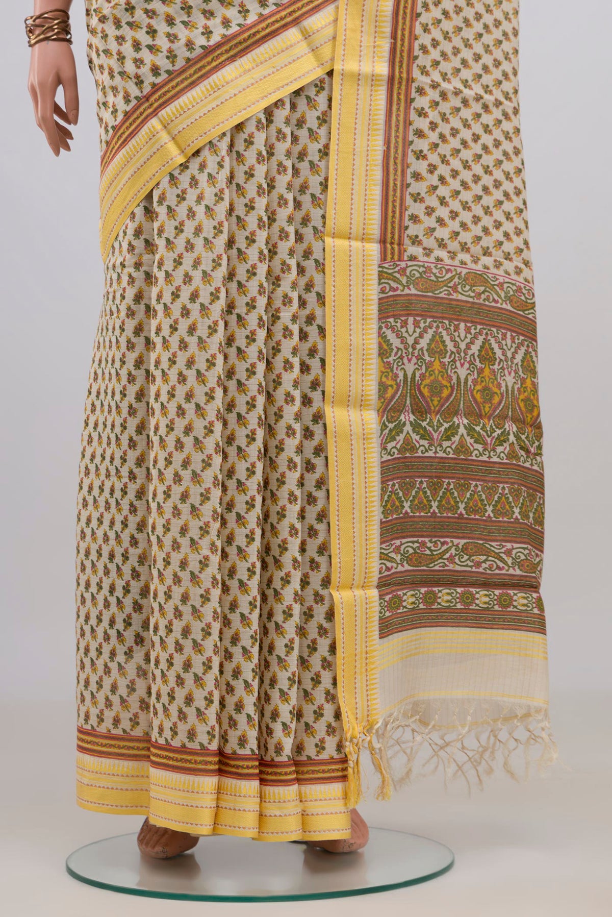 Pleats and pallu of Beige Tussar Saree with Printed design on the body and Thread Border. 
