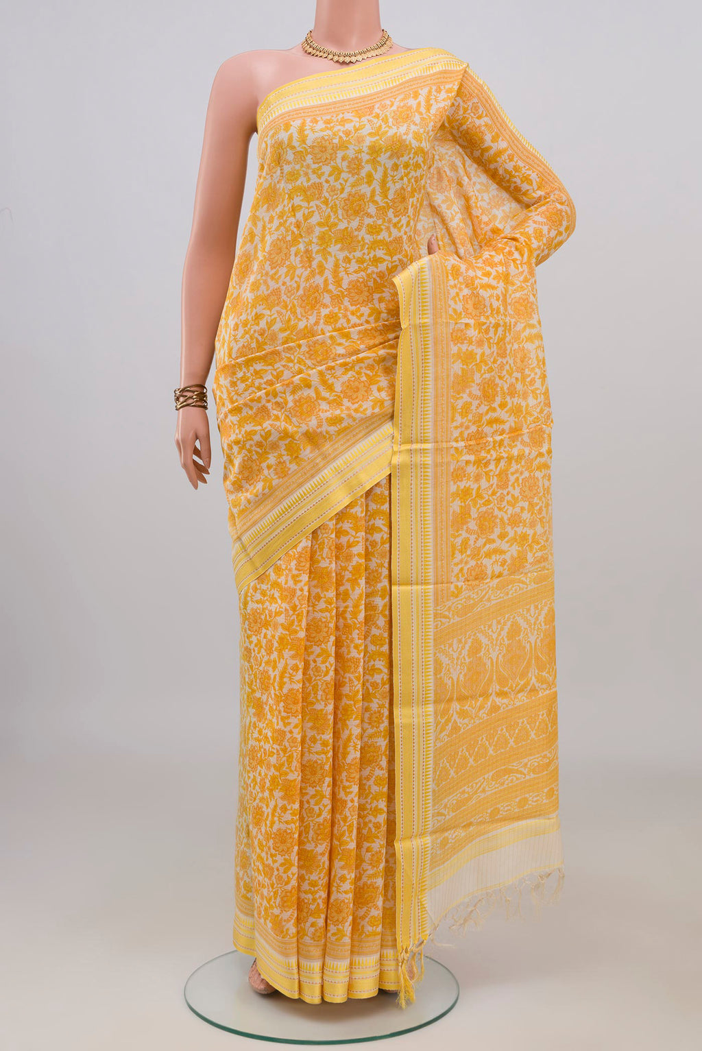 Yellow Tussar Saree with Floral Print on the body and Thread Border.  displayed on a mannequin