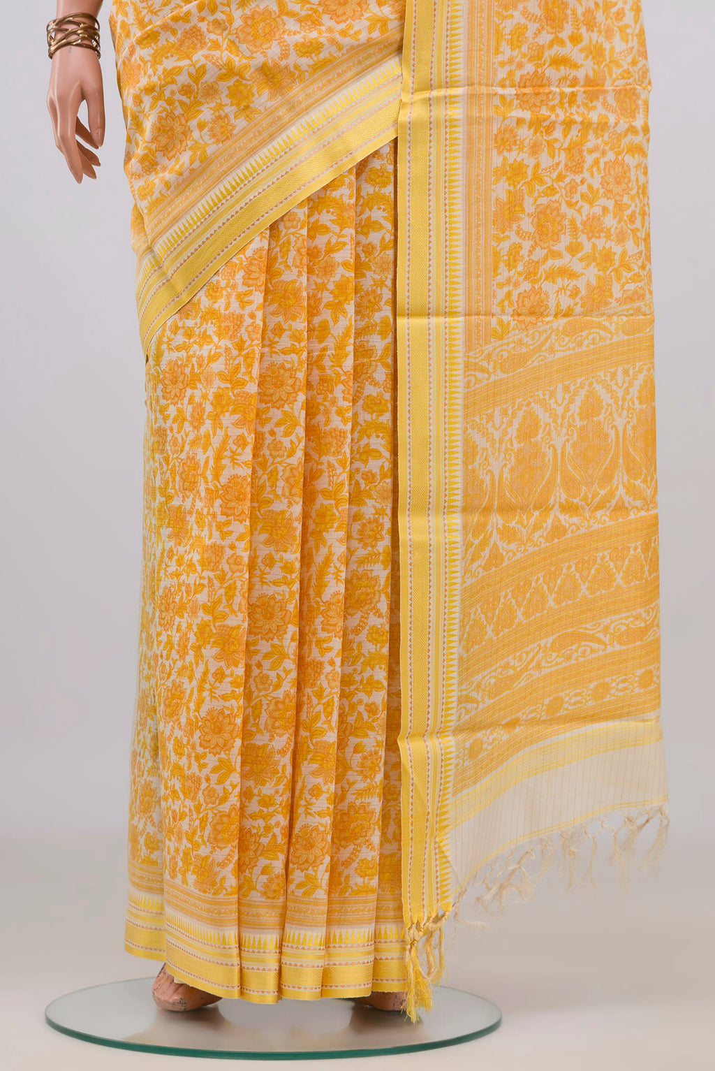 Pleats and pallu of Yellow Tussar Saree with Floral Print on the body and Thread Border. 