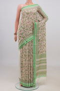 Beige Tussar Saree with Floral Print on the body and Thread Border.  displayed on a mannequin