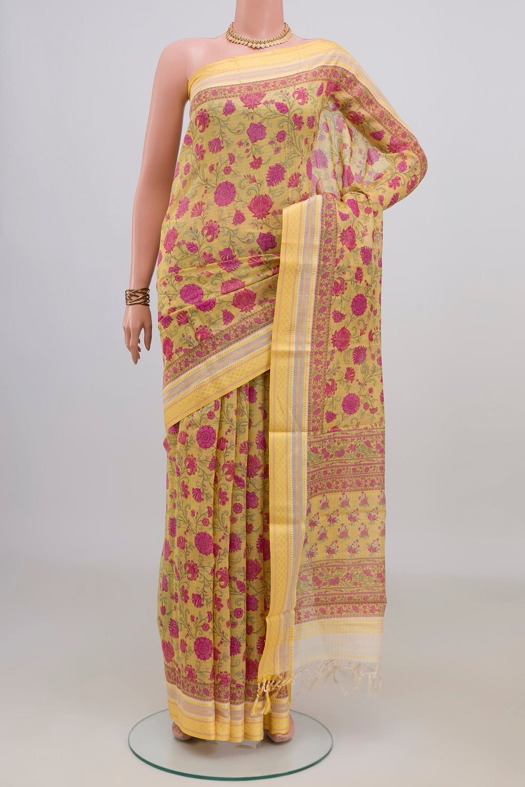 Yellow Tussar Saree with Floral Print on the body and Thread Border.  displayed on a mannequin