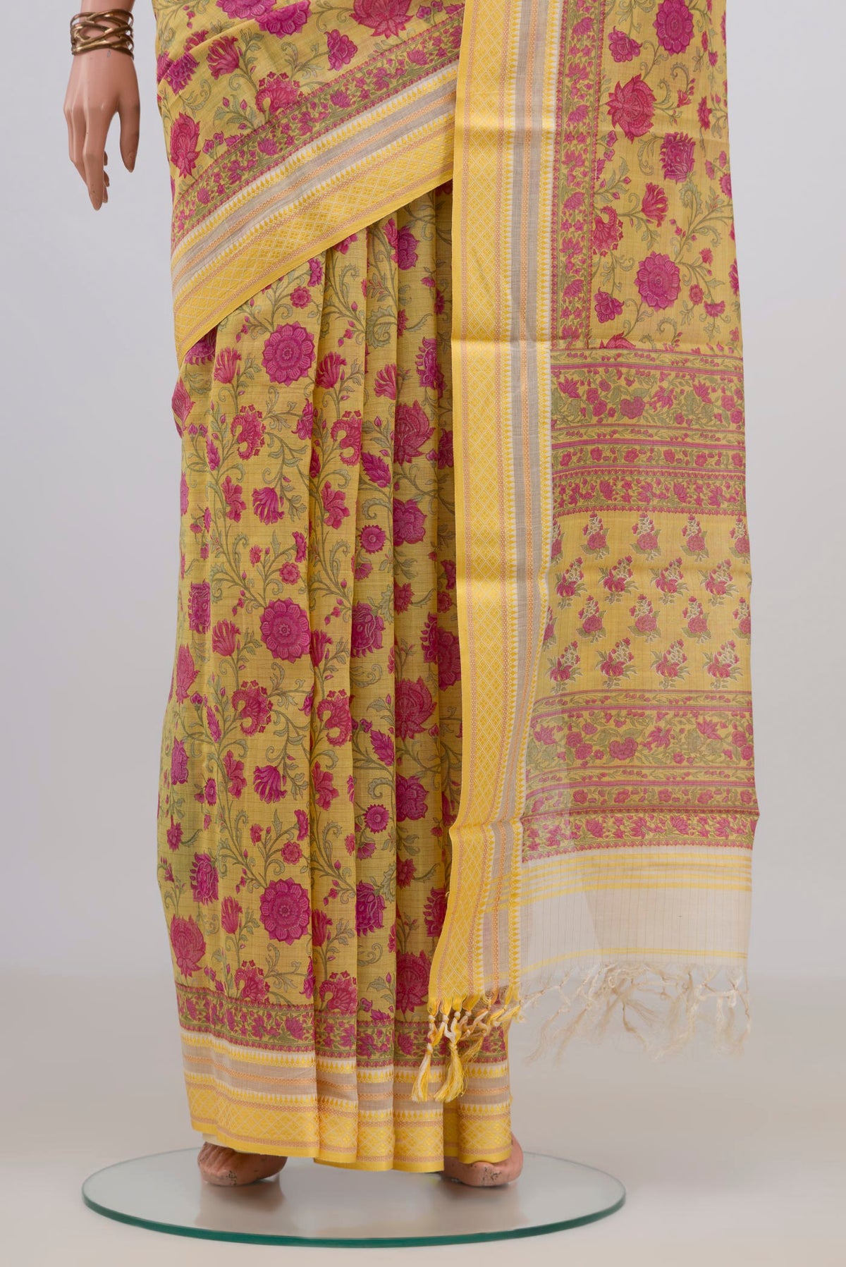 Pleats and pallu of Yellow Tussar Saree with Floral Print on the body and Thread Border. 
