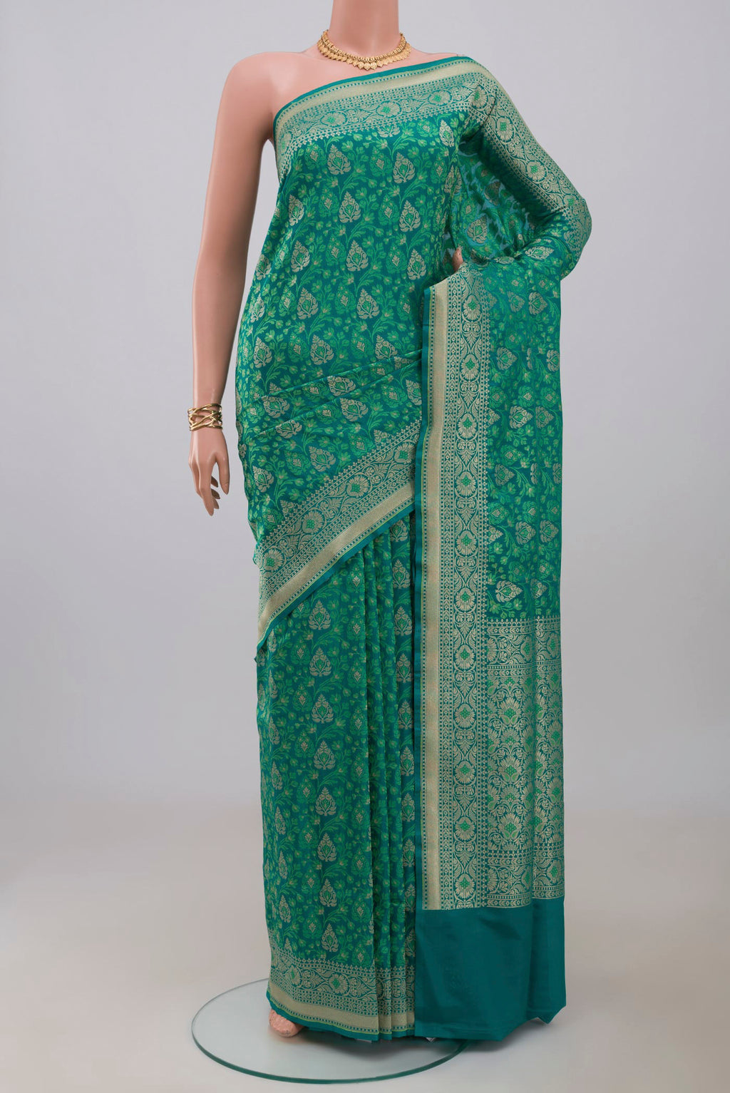 Green Banarasi Saree with Fancy on the body and Fancy Border.  displayed on a mannequin