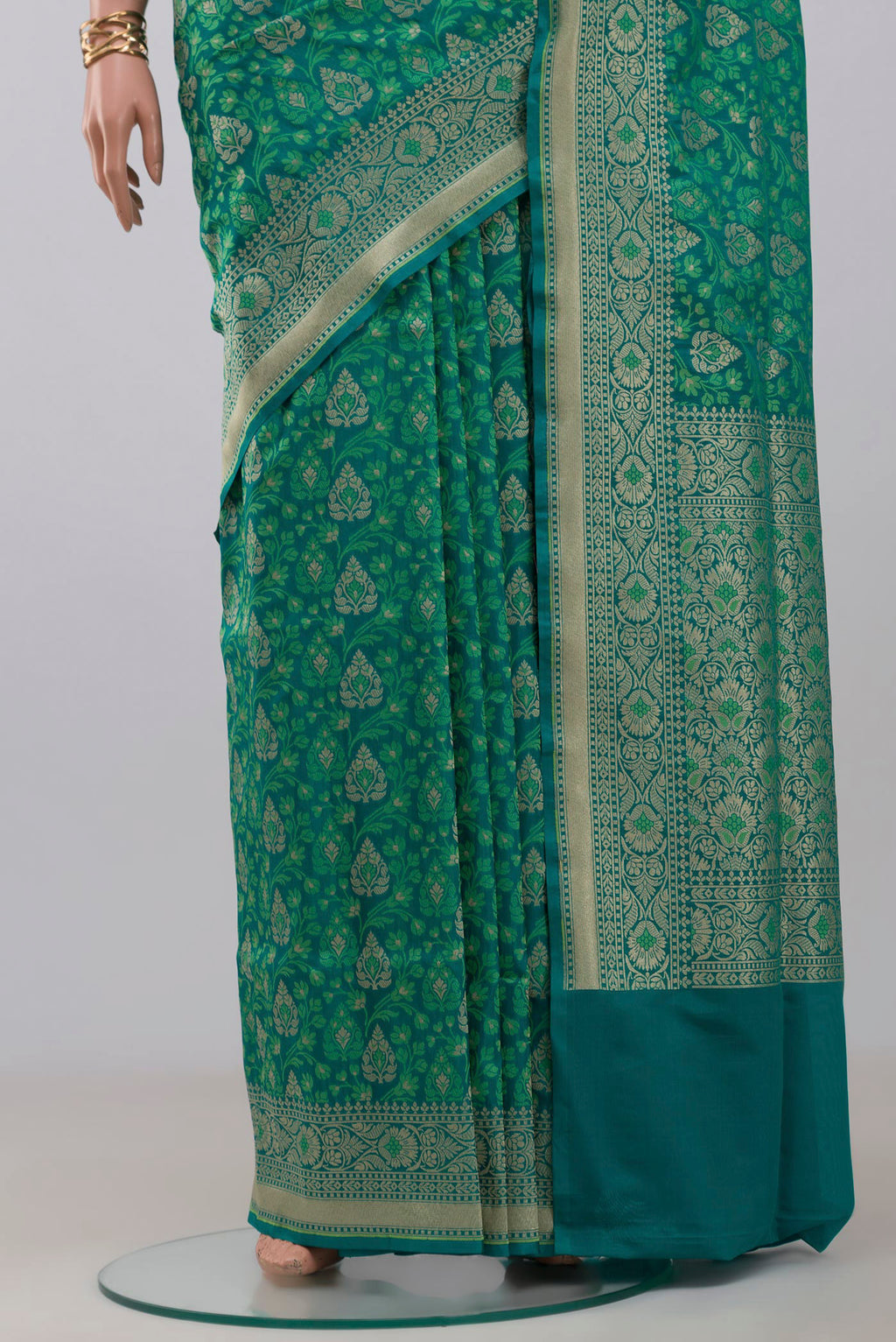 Pleats and pallu of Green Banarasi Saree with Fancy on the body and Fancy Border. 