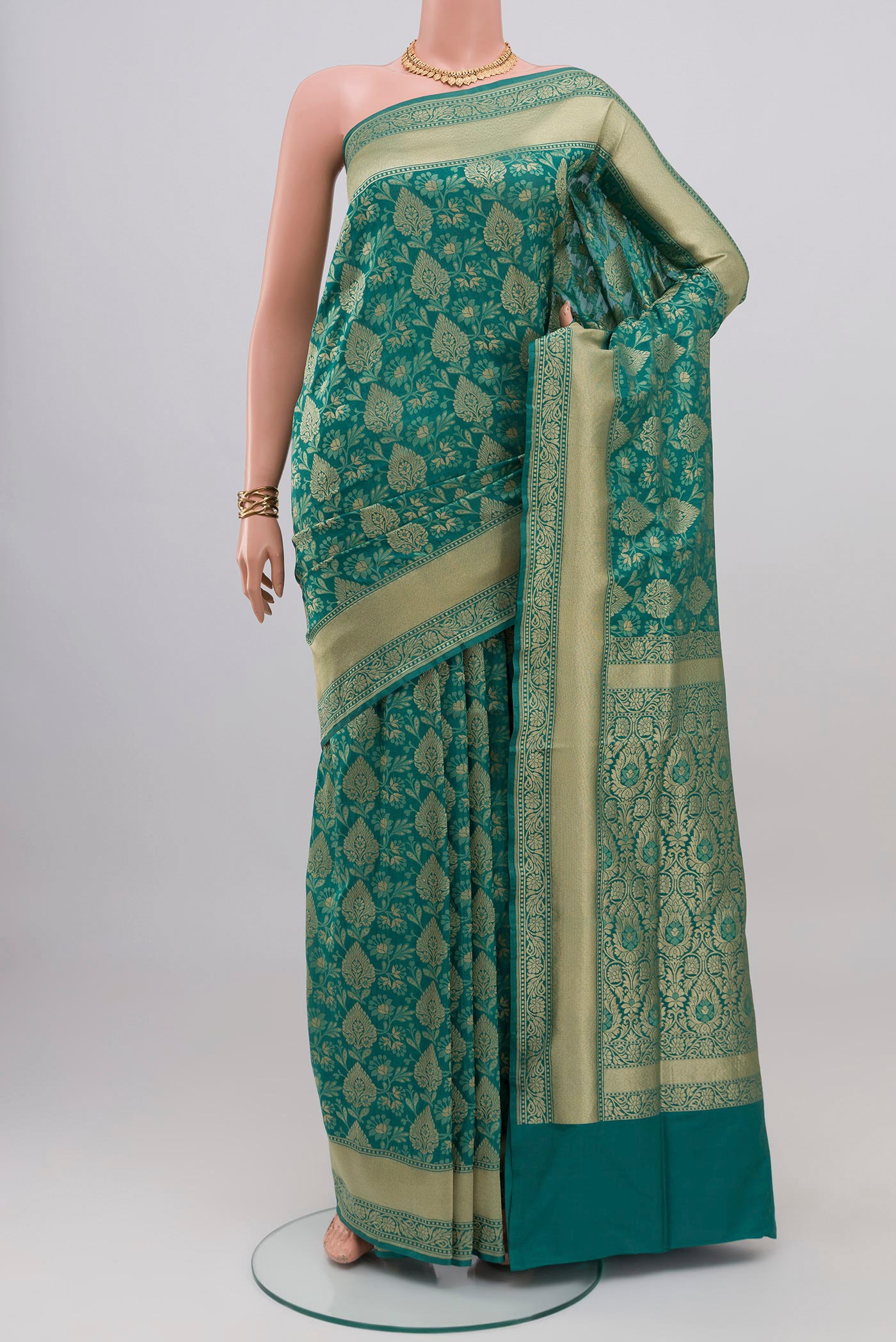 Turquoise Banarasi Silk Saree with Zari And Thread Butta on the body and Zari Border.  displayed on a mannequin