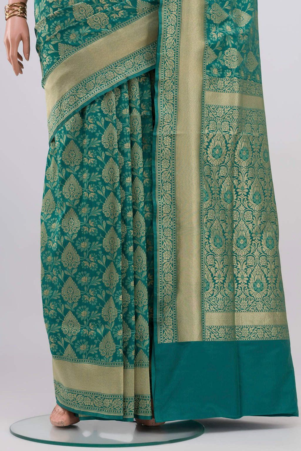 Pleats and pallu of Turquoise Banarasi Silk Saree with Zari And Thread Butta on the body and Zari Border. 