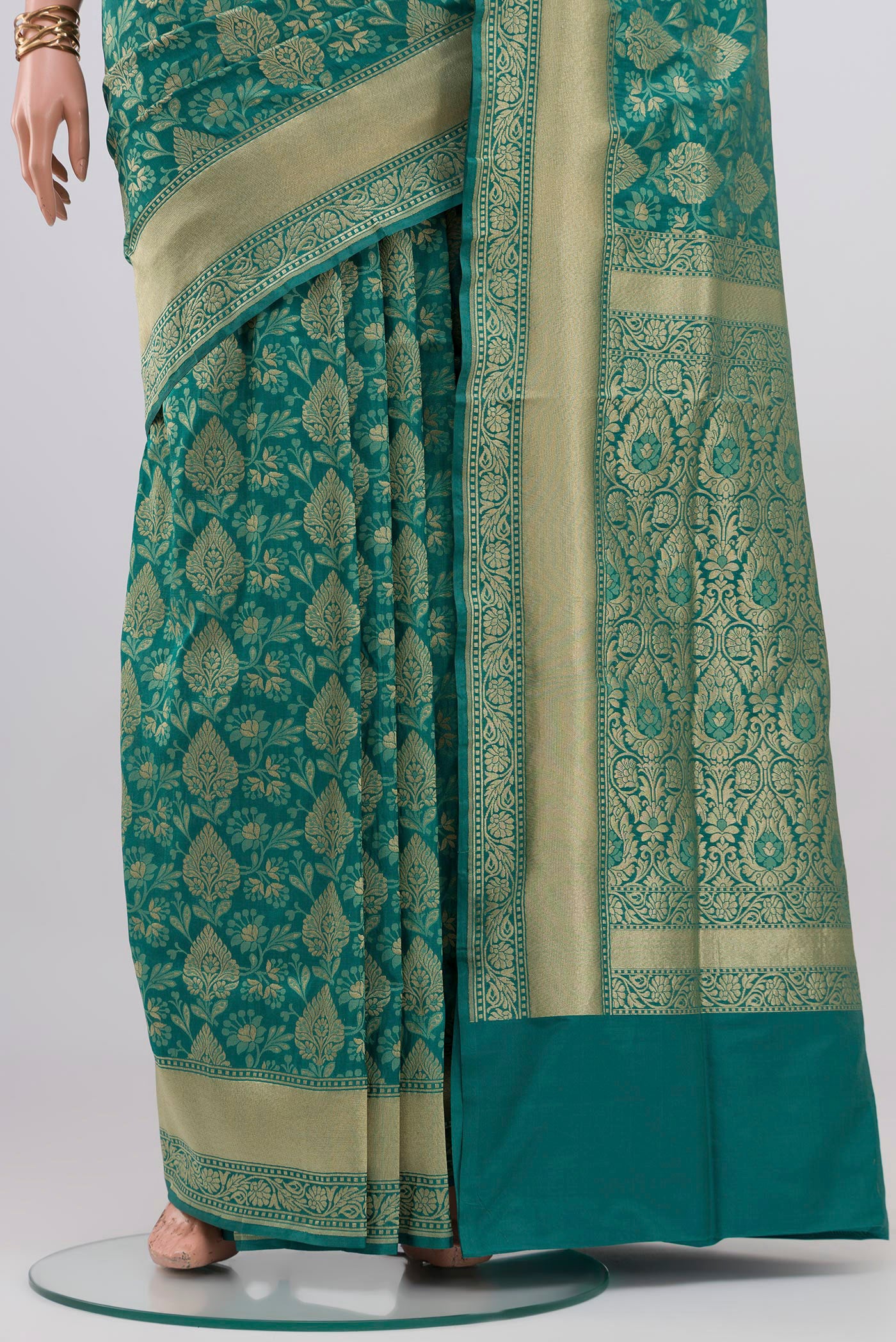 Pleats and pallu of Turquoise Banarasi Silk Saree with Zari And Thread Butta on the body and Zari Border. 