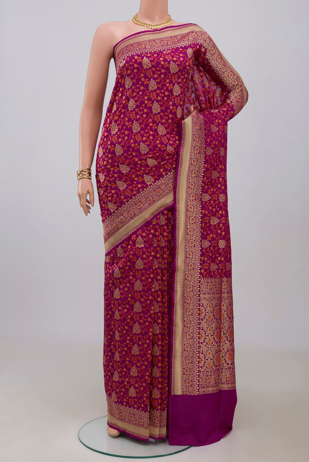 Magenta Banarasi Saree with Fancy on the body and Fancy Border.  displayed on a mannequin