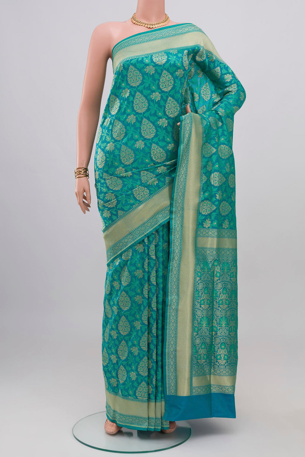 Blue Banarasi Silk Saree with Zari And Thread Butta on the body and Zari Border.  displayed on a mannequin