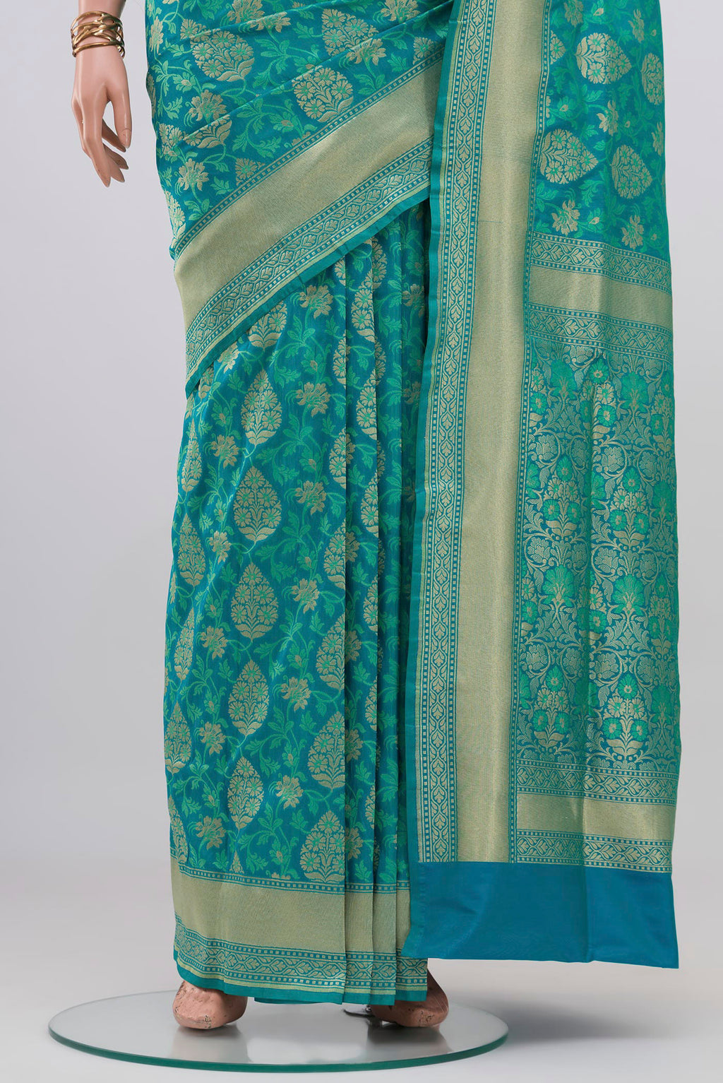 Pleats and pallu of Blue Banarasi Silk Saree with Zari And Thread Butta on the body and Zari Border. 